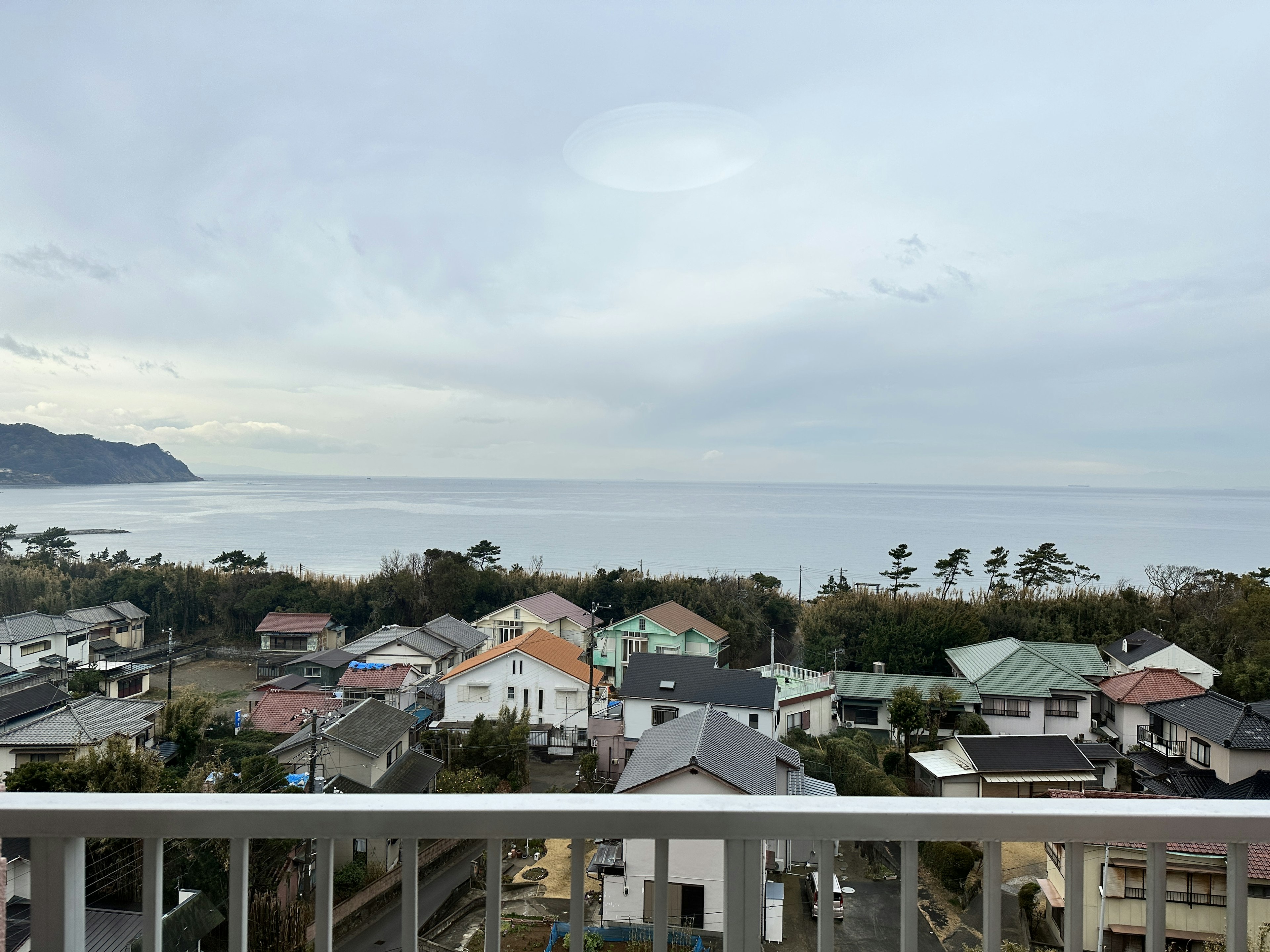 Scenic view of houses with the ocean in the background