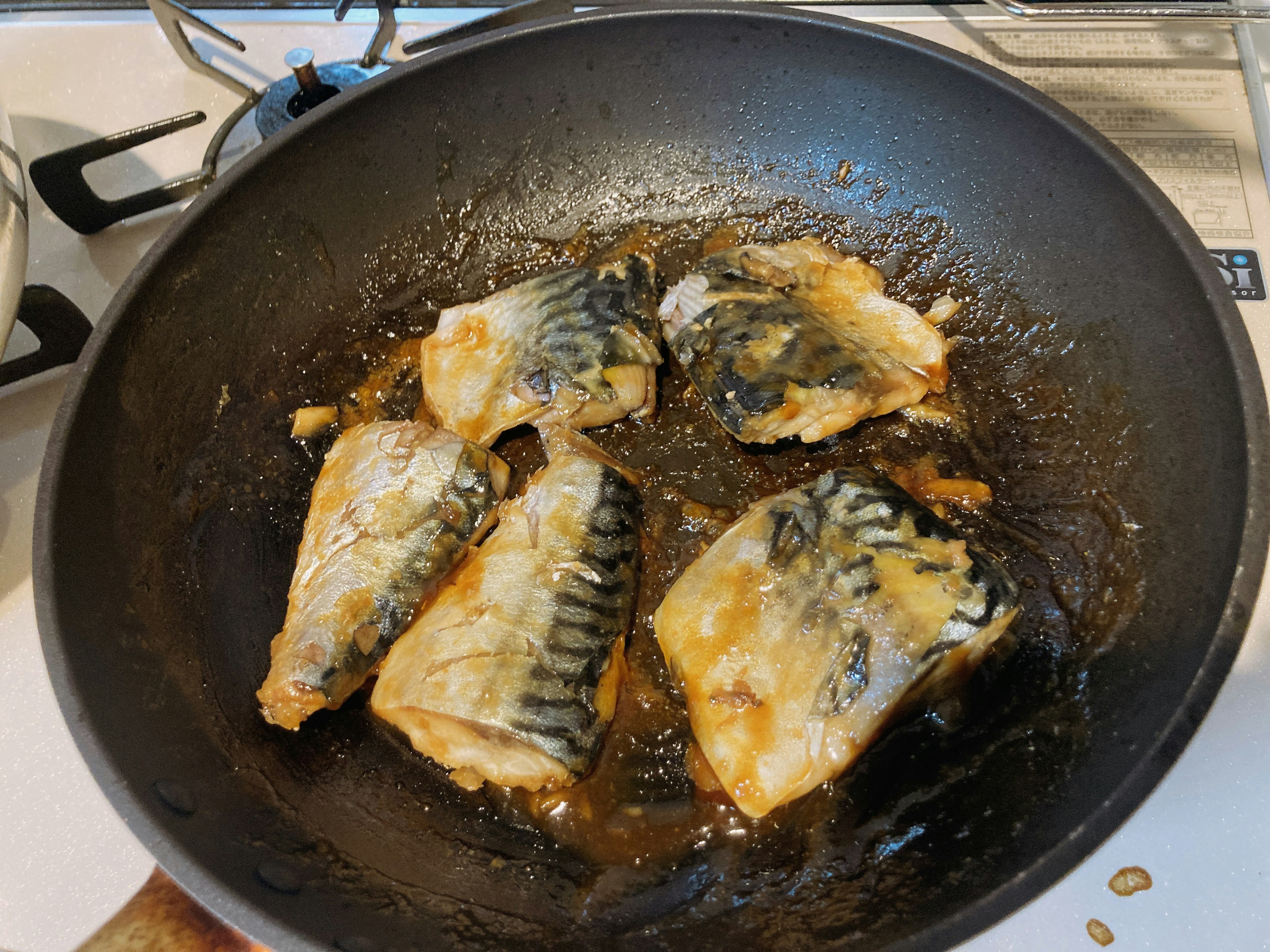 Fish fillets being cooked in a frying pan