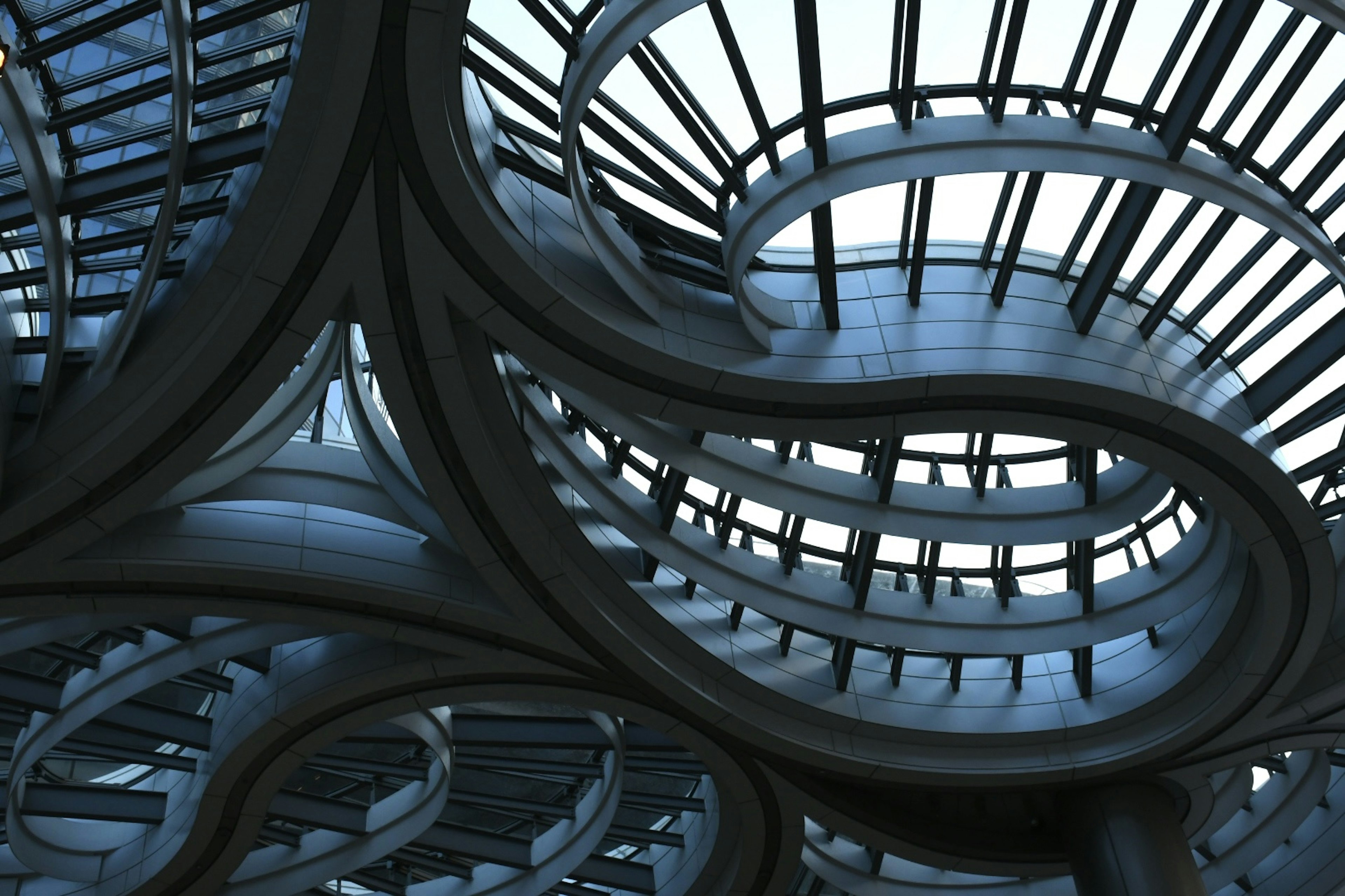 Futuristic spiral structure with metallic framework inside a building