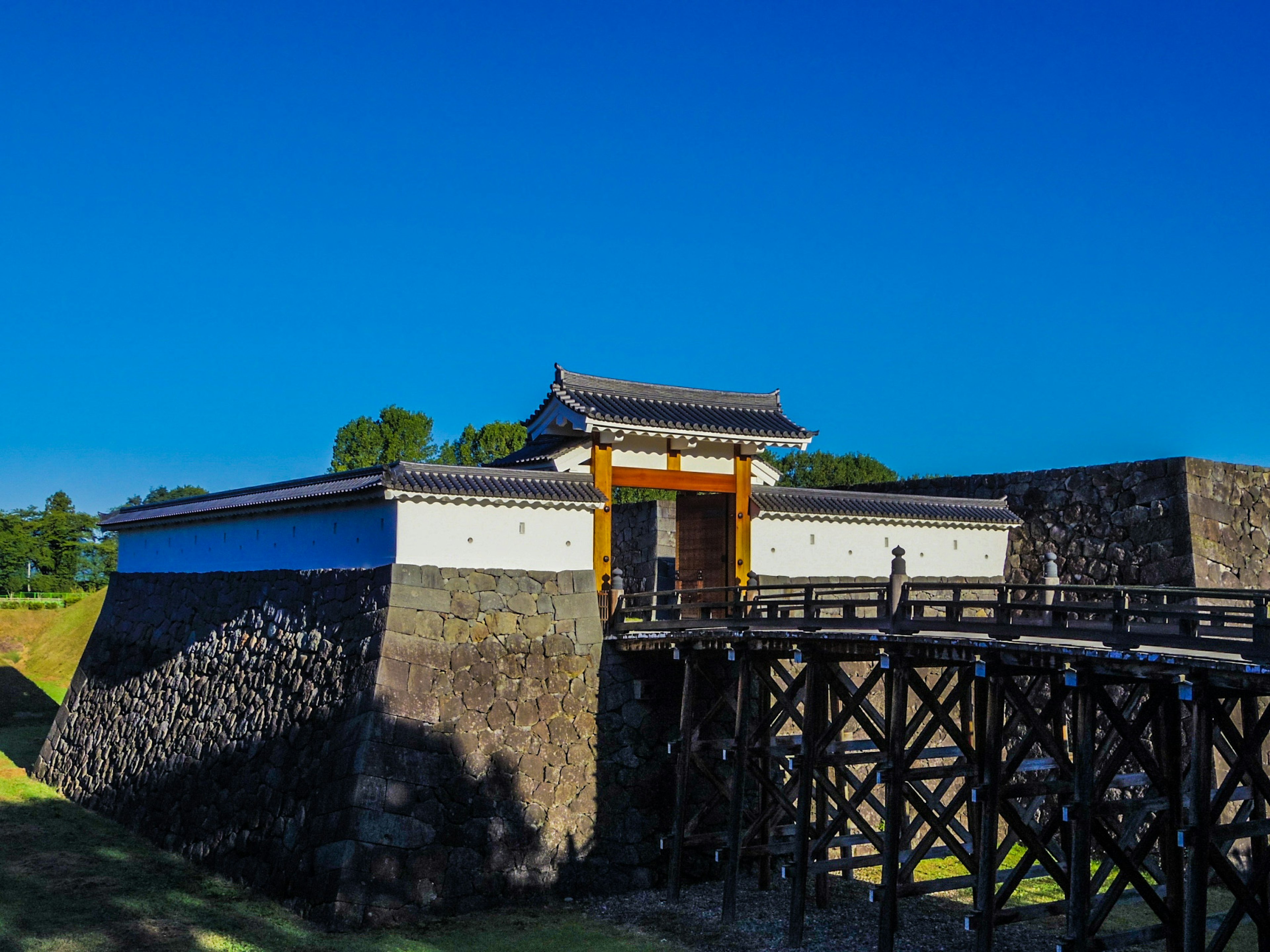 Beautiful landscape featuring a castle gate and a wooden bridge