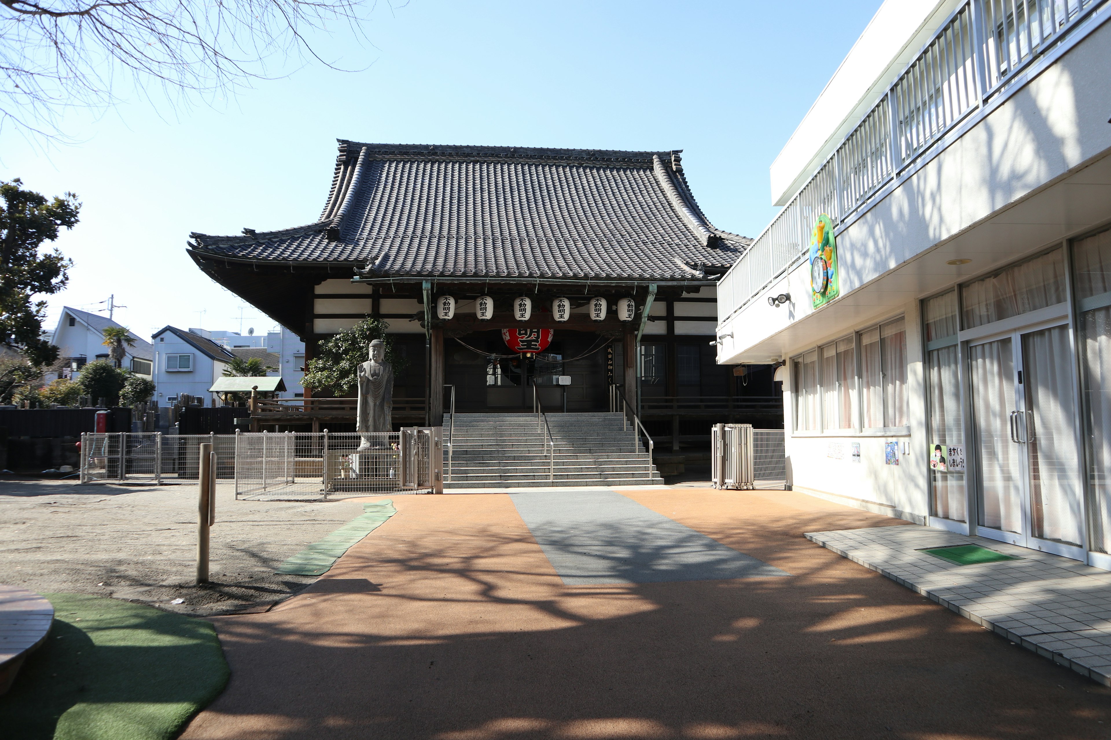 Traditional Japanese temple building alongside a modern structure