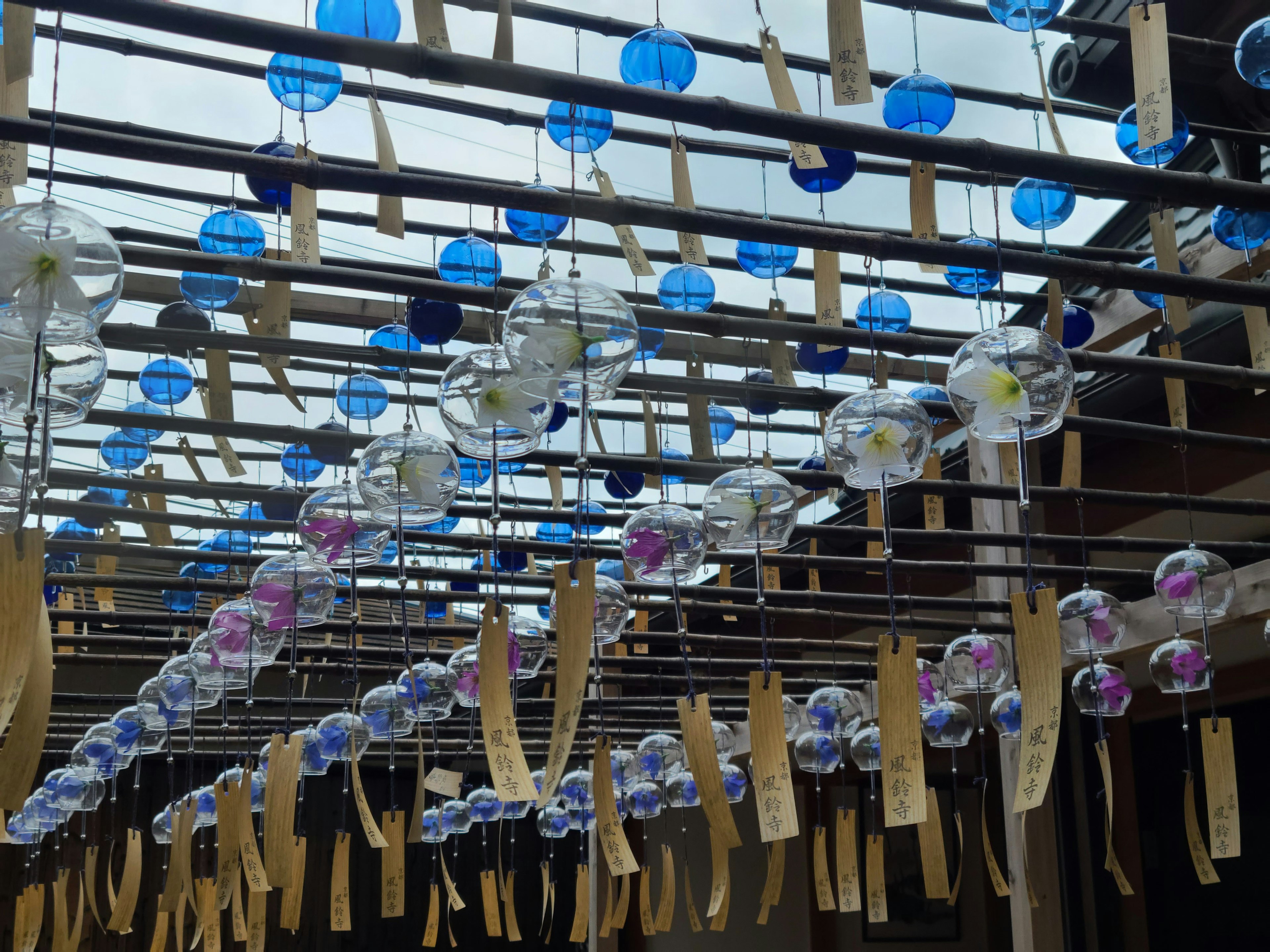 Outdoor space adorned with blue and clear wind chimes