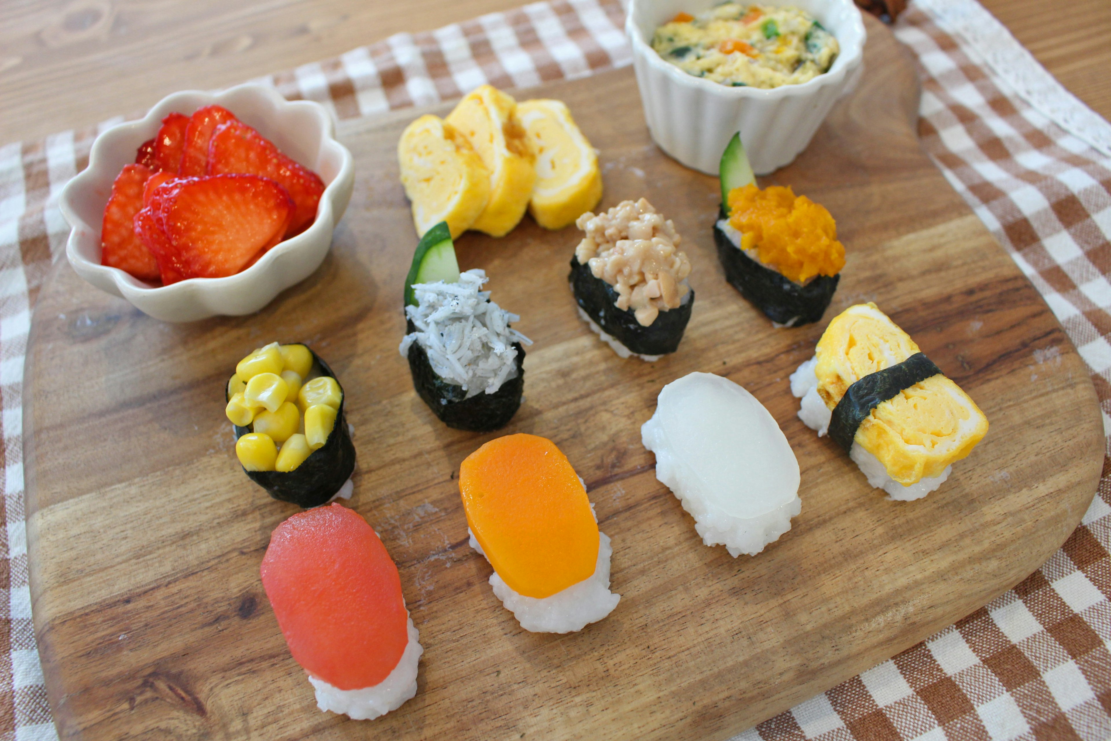 Colorful sushi platter with strawberries and egg