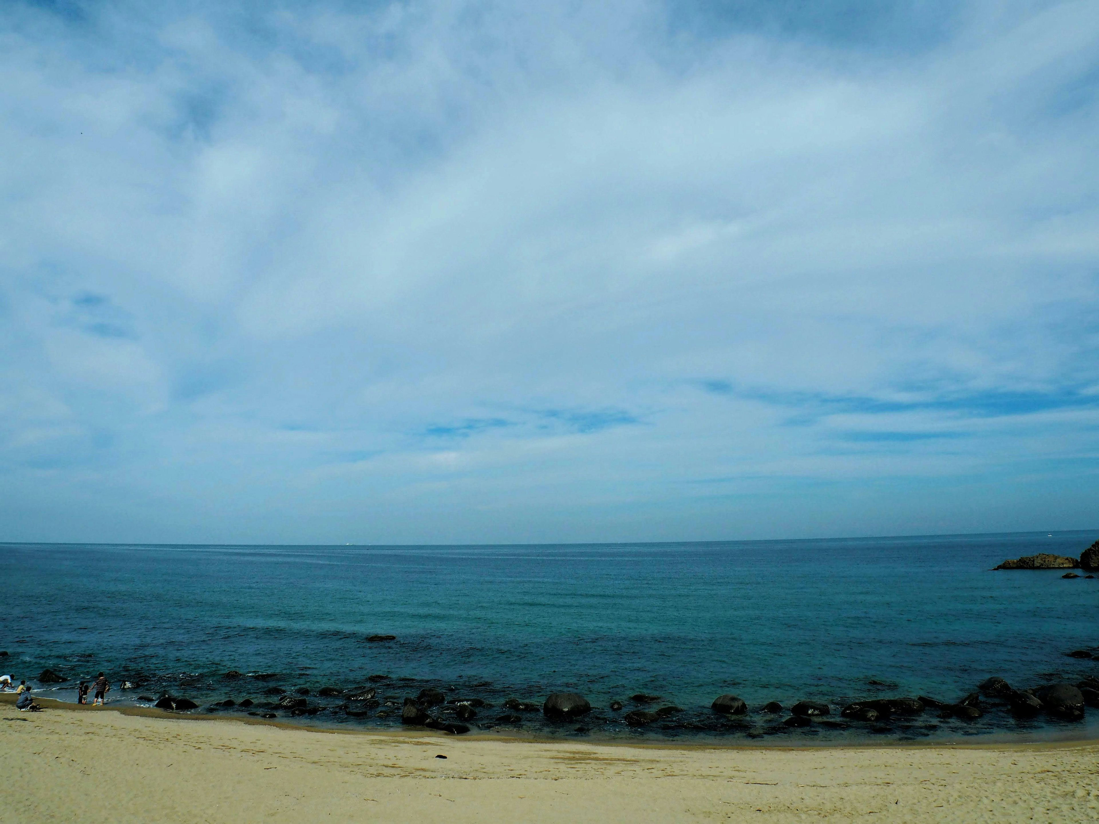 Scenic view of a beach with blue ocean and sandy shore