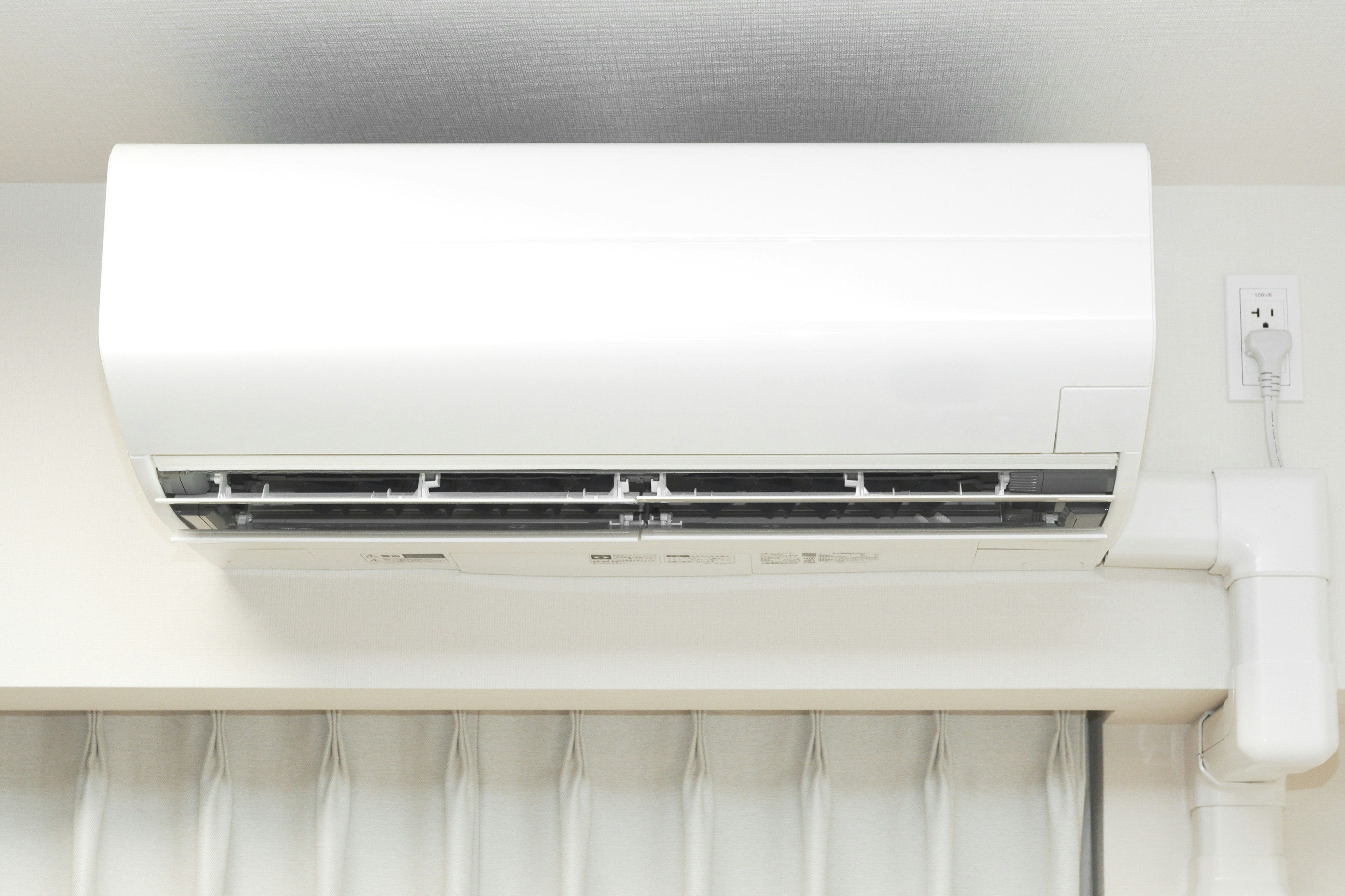 Indoor image of a white air conditioner mounted on the wall