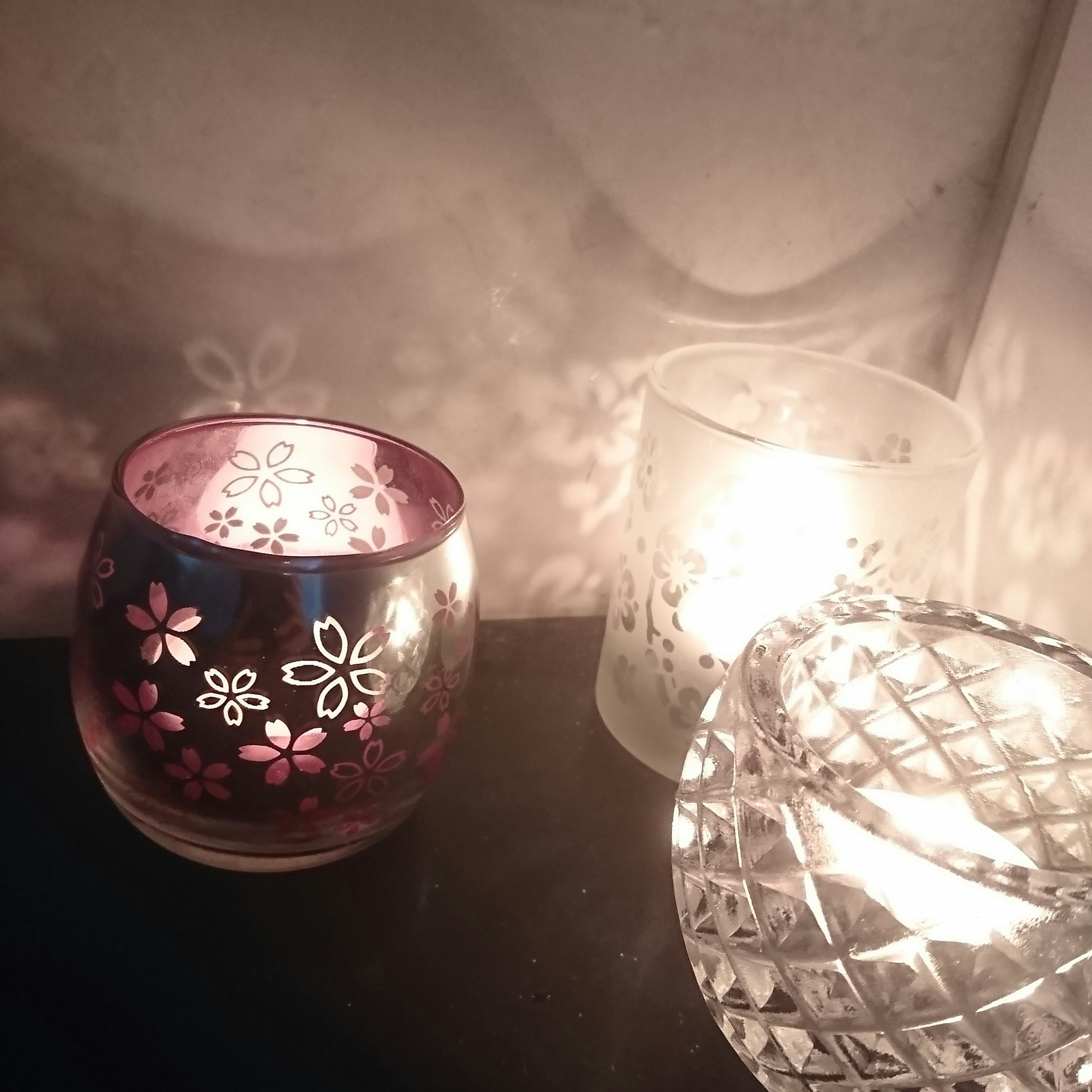 A warm scene featuring floral patterned candle holders and a crystal candle holder