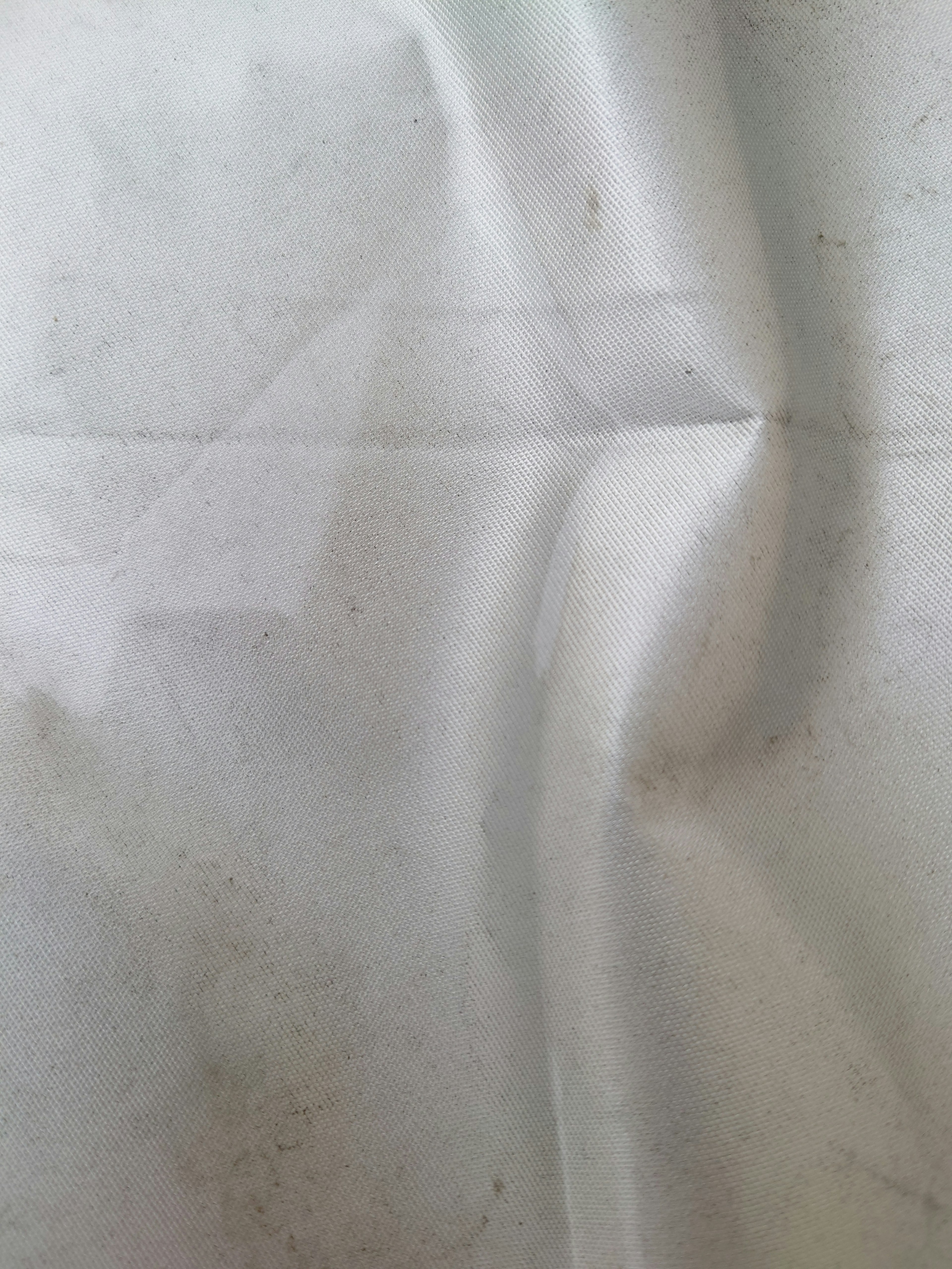 Image of a wrinkled white fabric with stains