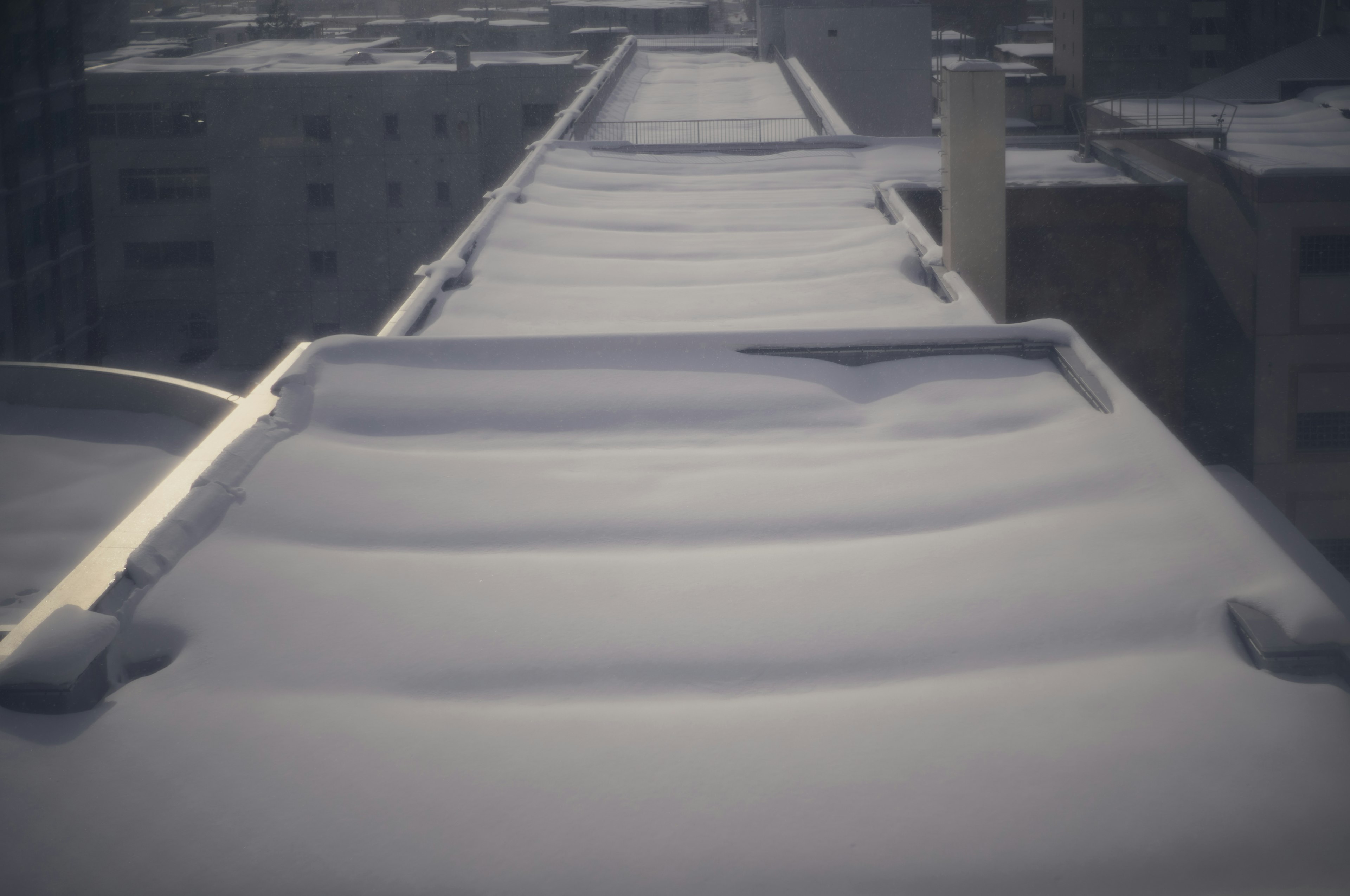 Snow-covered rooftop with smooth surfaces