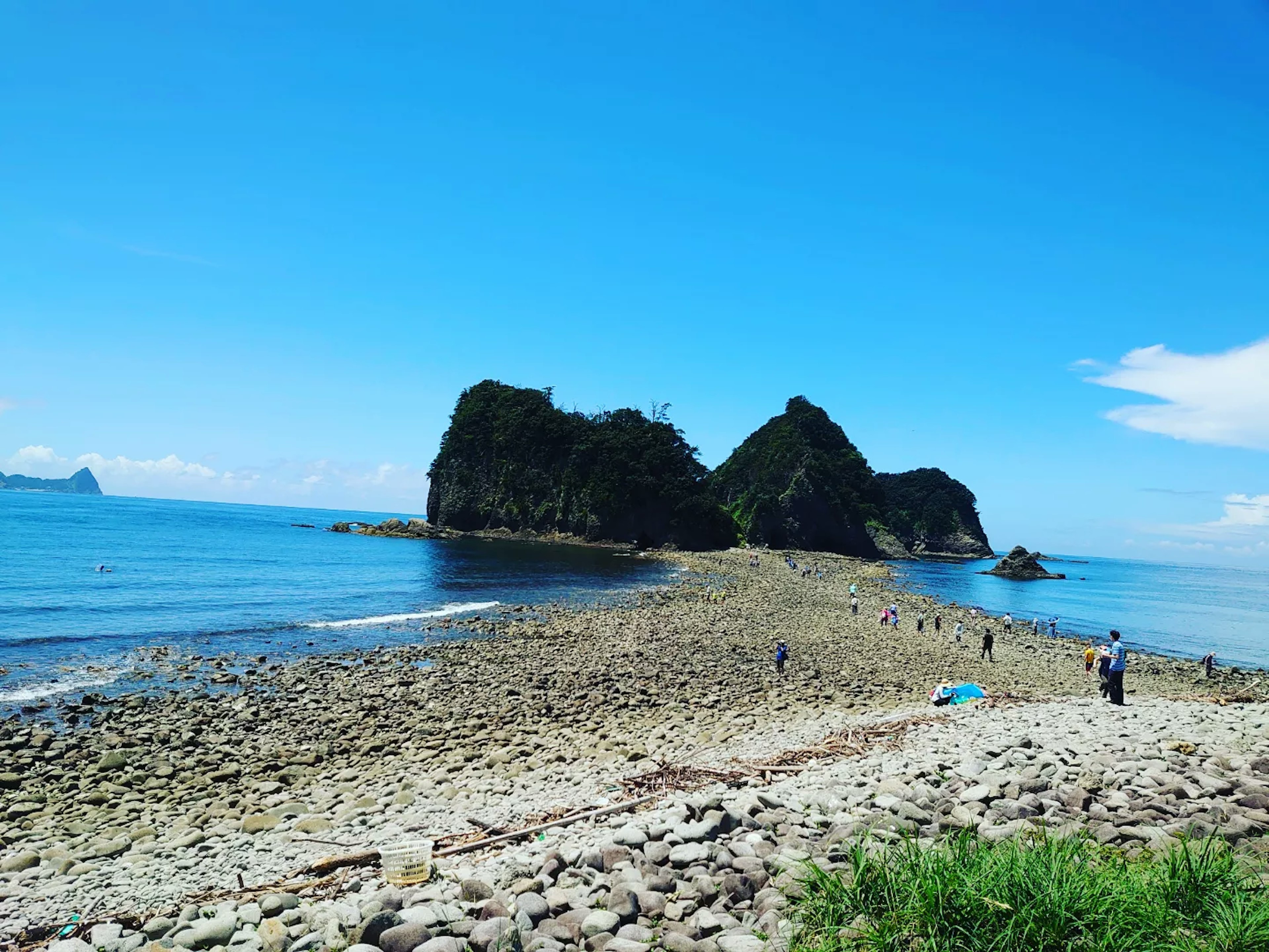 Coastal view featuring rocky islands and a clear blue sky