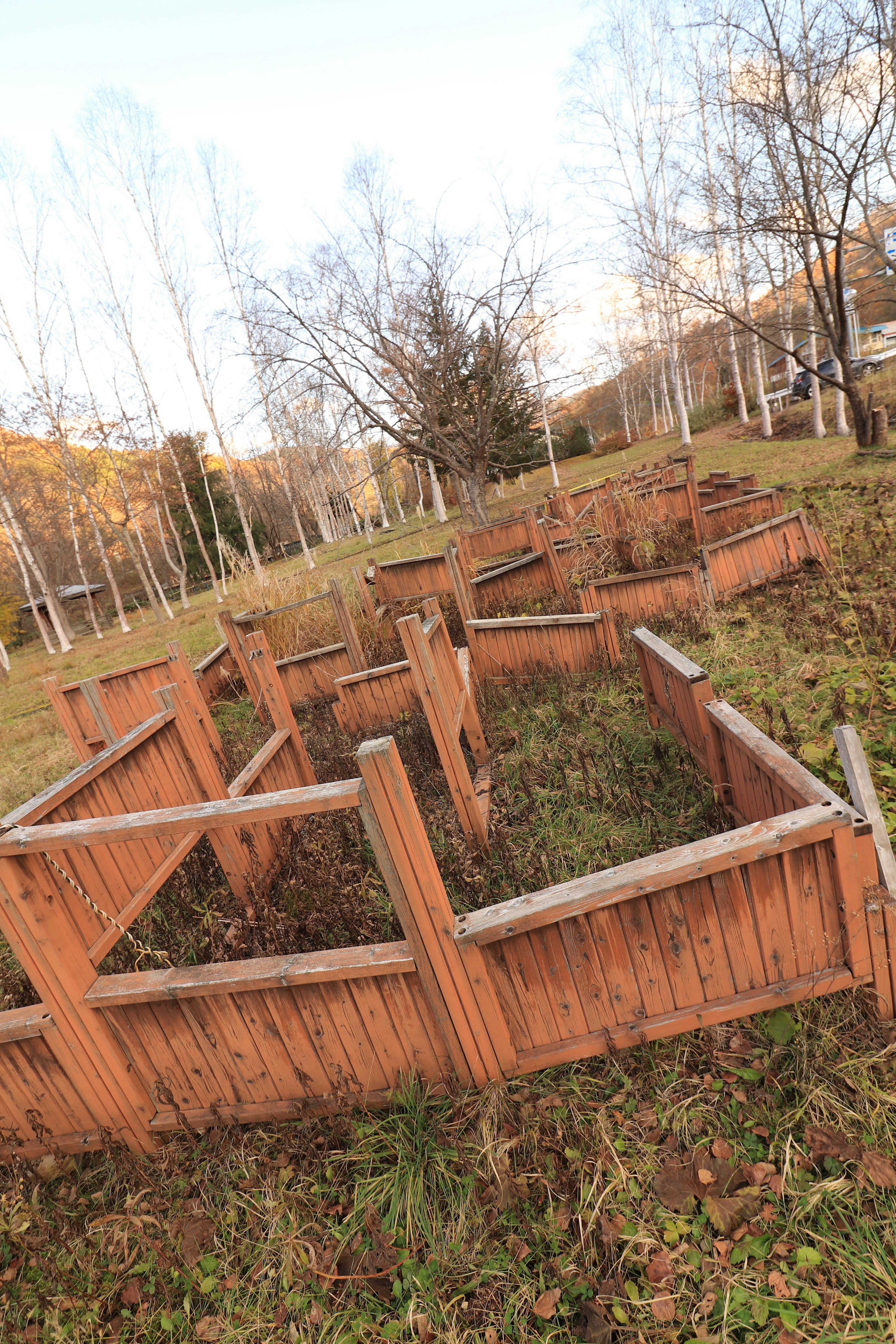 Wooden enclosures arranged in a green grassy area