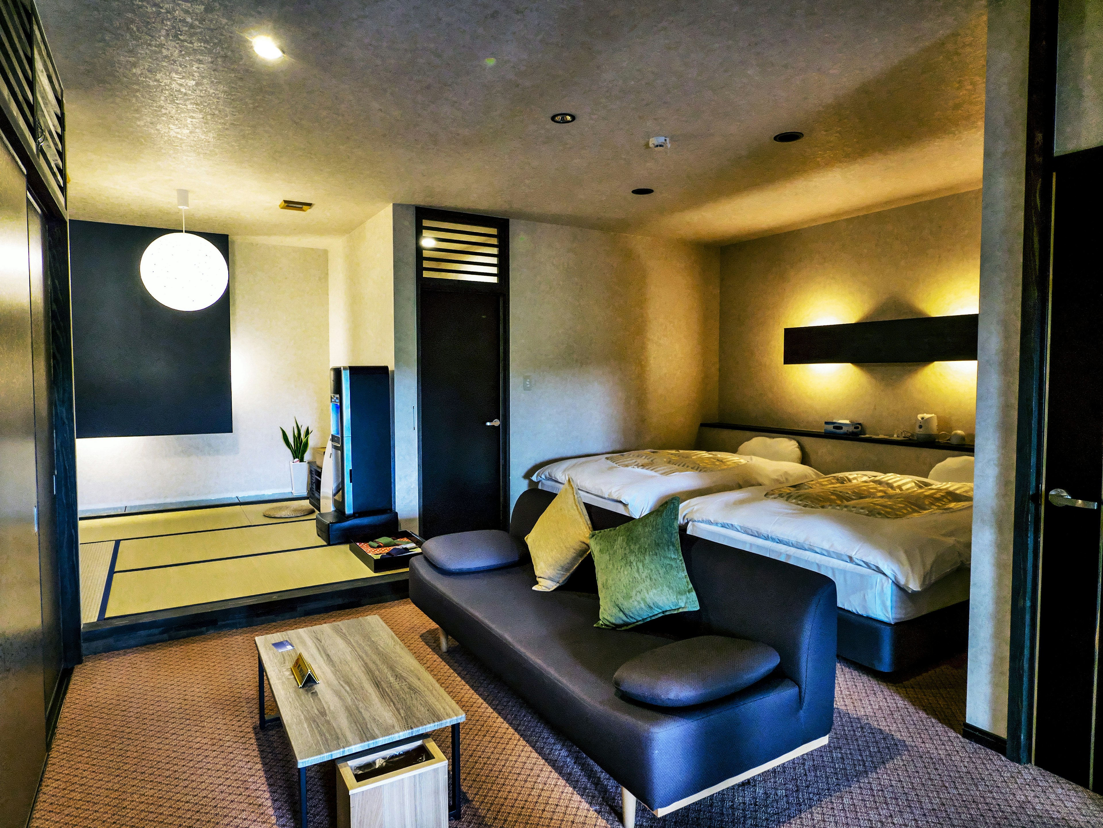 Interior of a modern accommodation featuring a blend of Japanese tatami and Western-style bedding