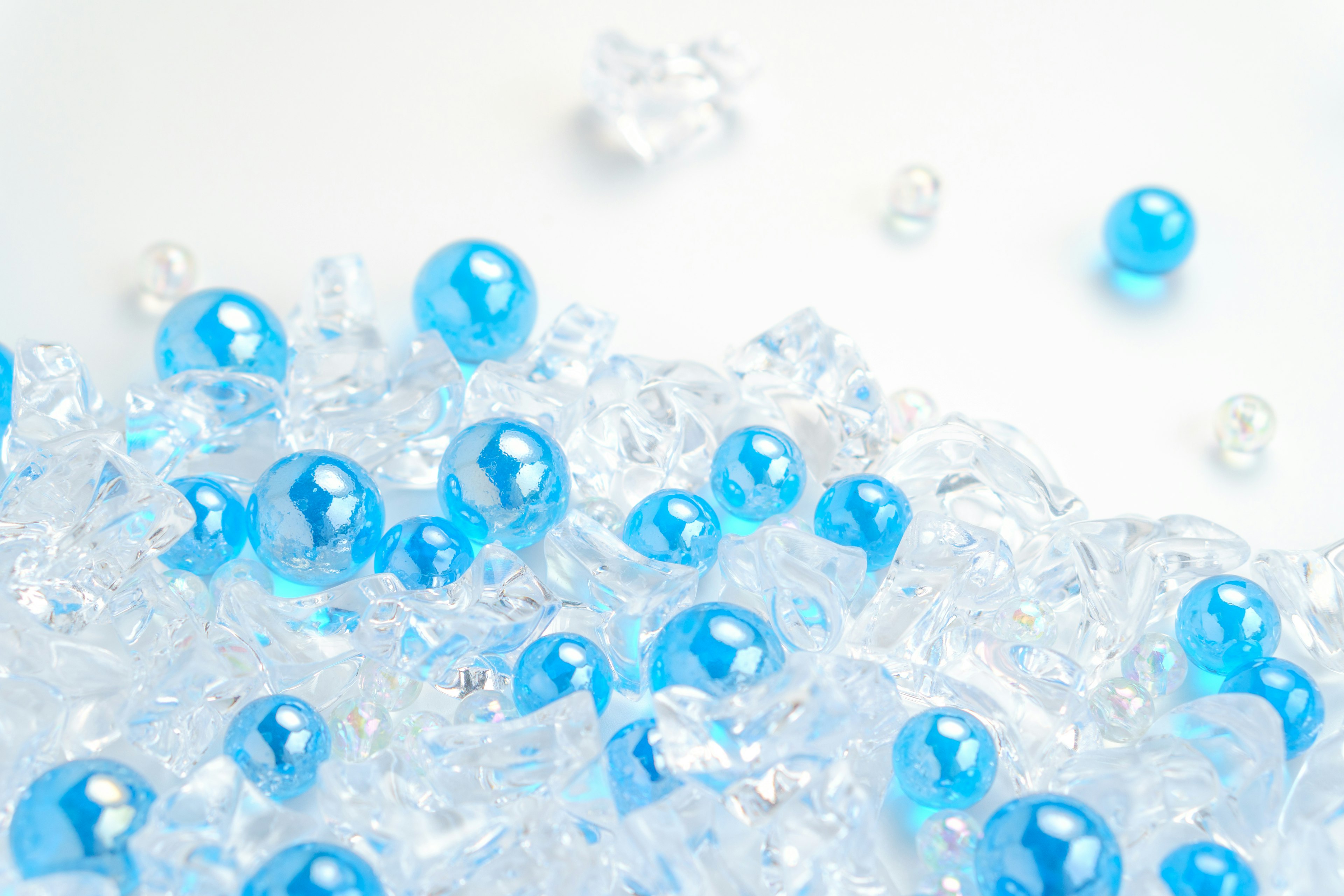 A collection of transparent beads with scattered blue spheres