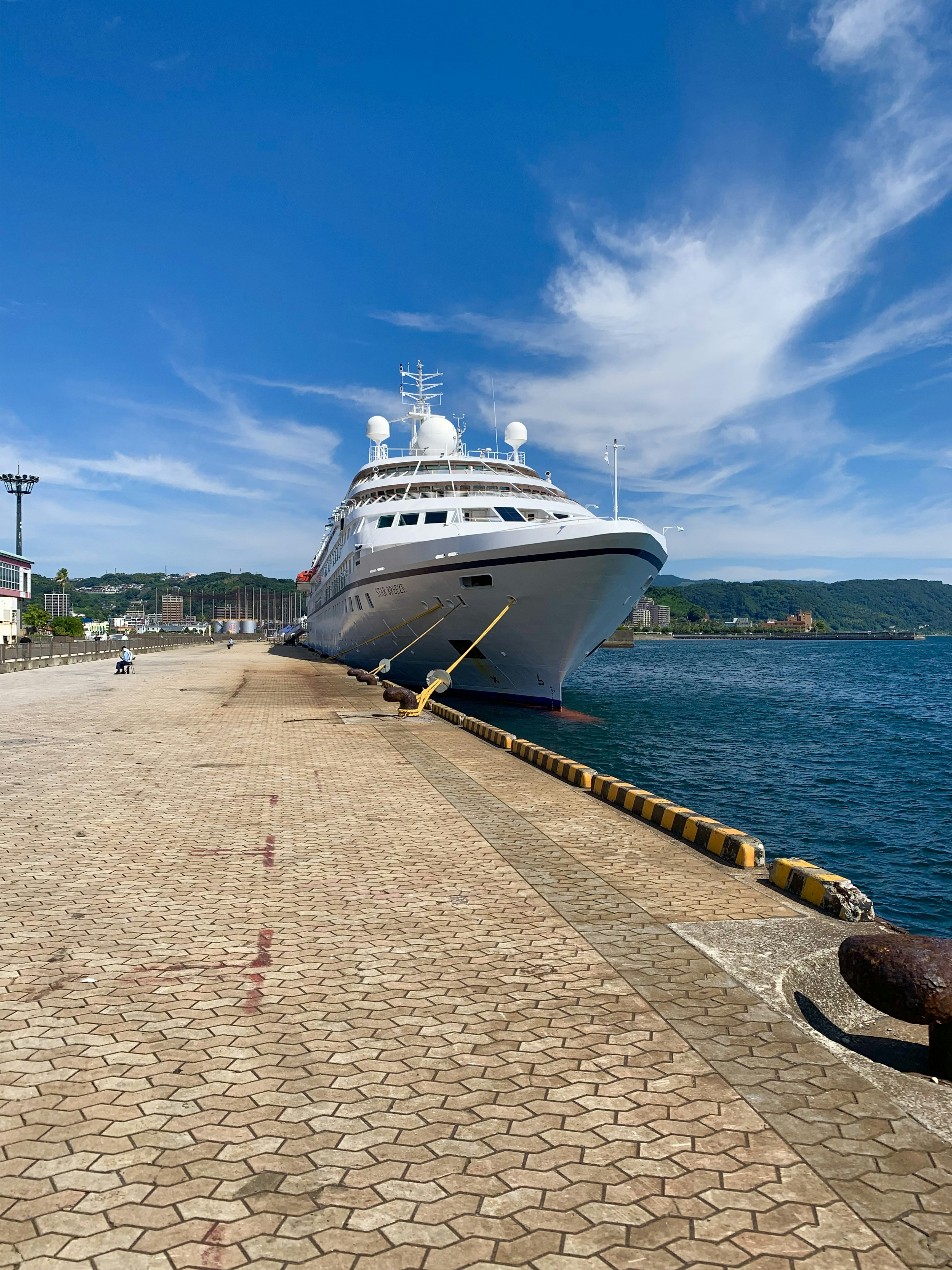 Großes Kreuzfahrtschiff am Ufer unter einem klaren blauen Himmel