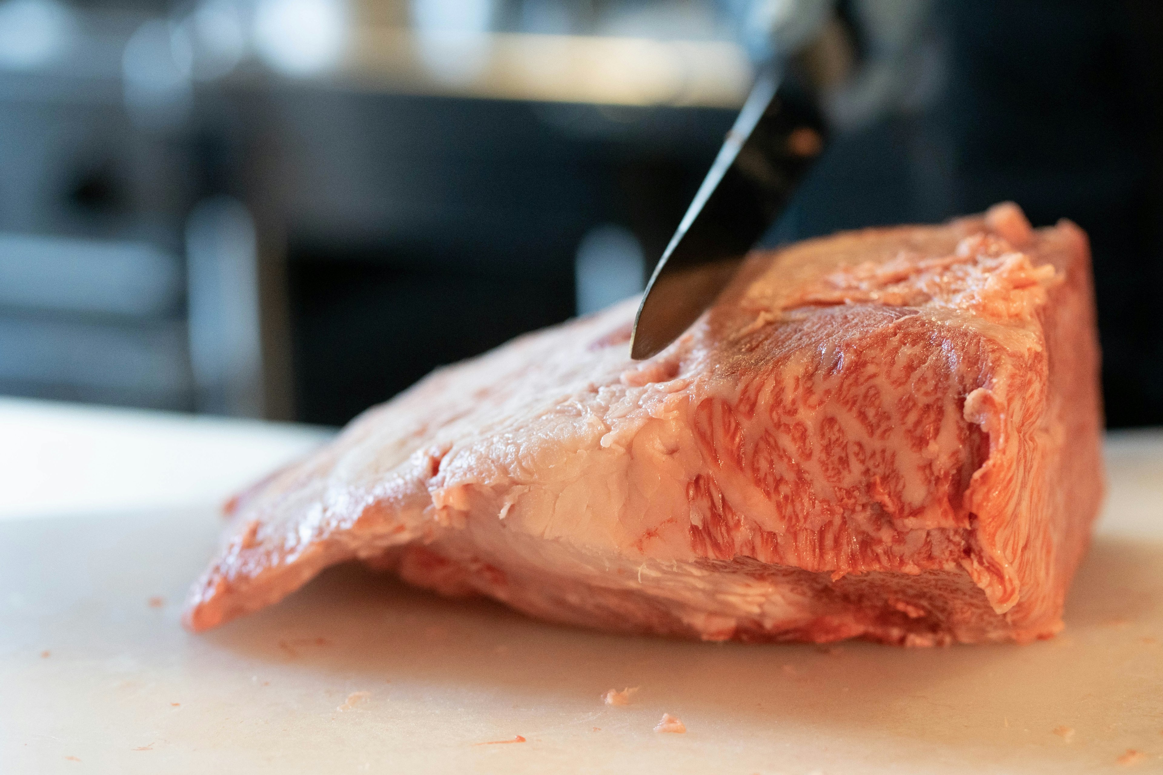 Image of a knife cutting into a piece of meat