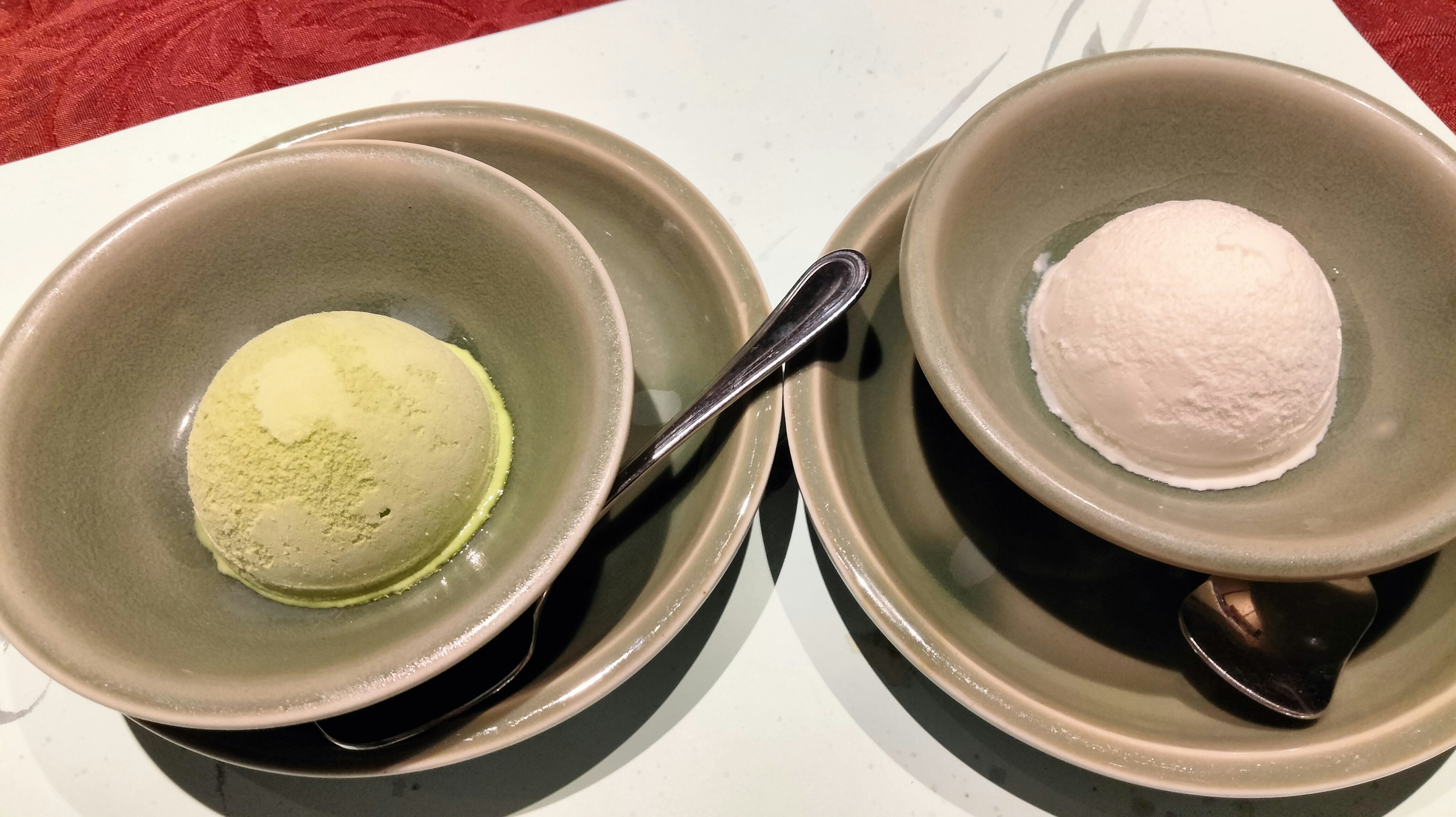 Green tea ice cream and vanilla ice cream served in bowls