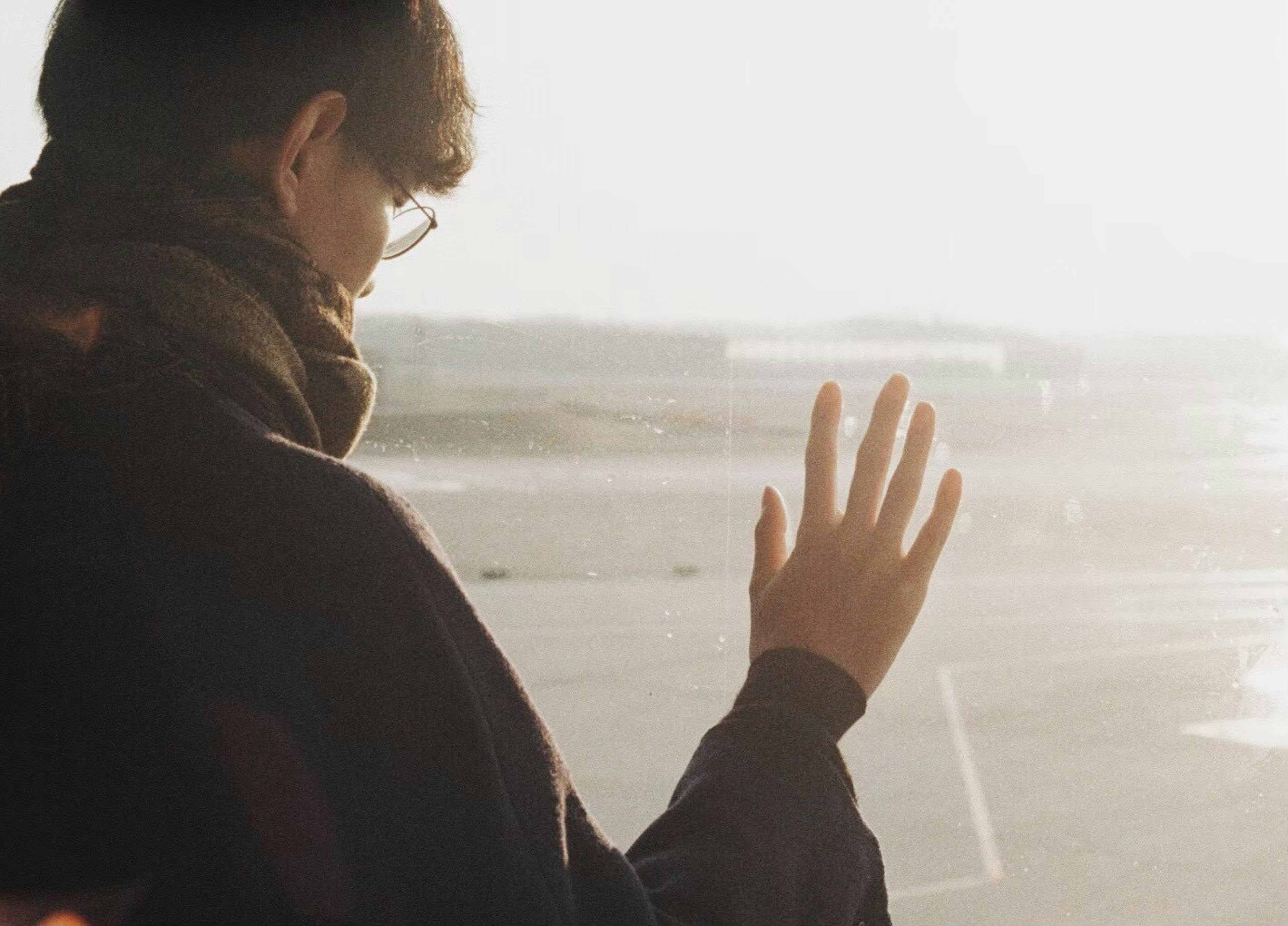 Silhouette of a person waving at the airport