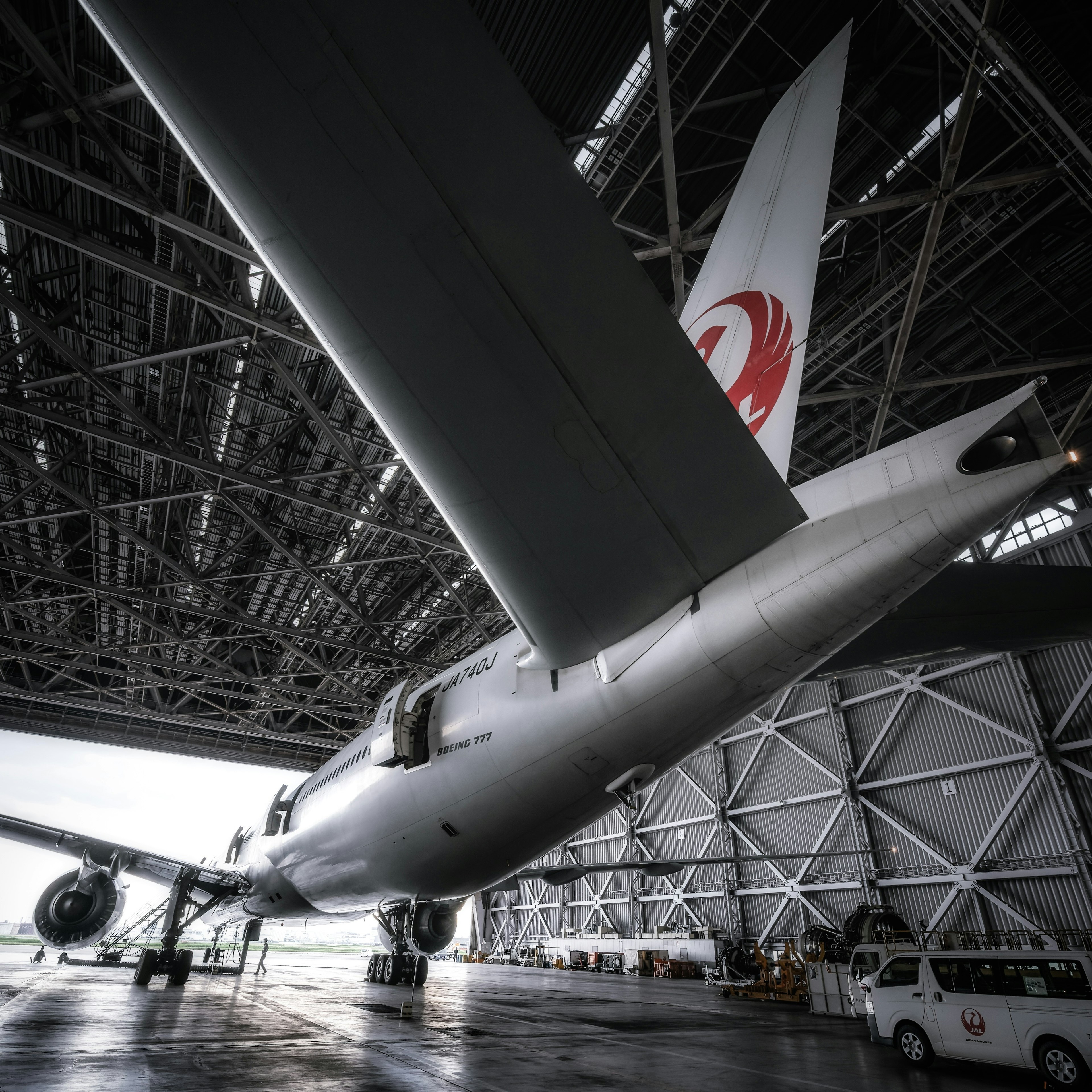 Airplane inside a hangar featuring a red logo on the wing