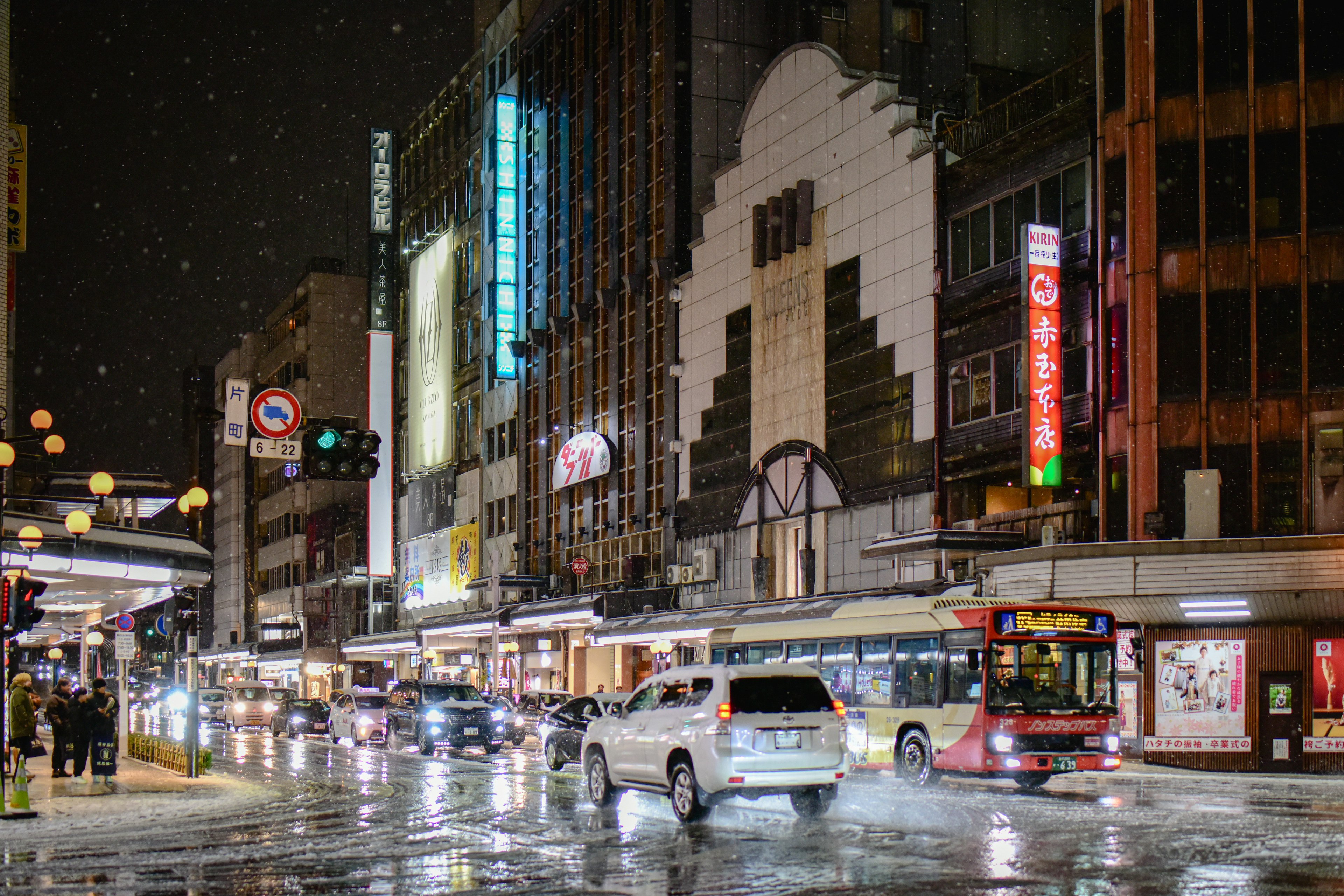 夜の都市景観で雨が降る中での交通の様子とアールデコ建築