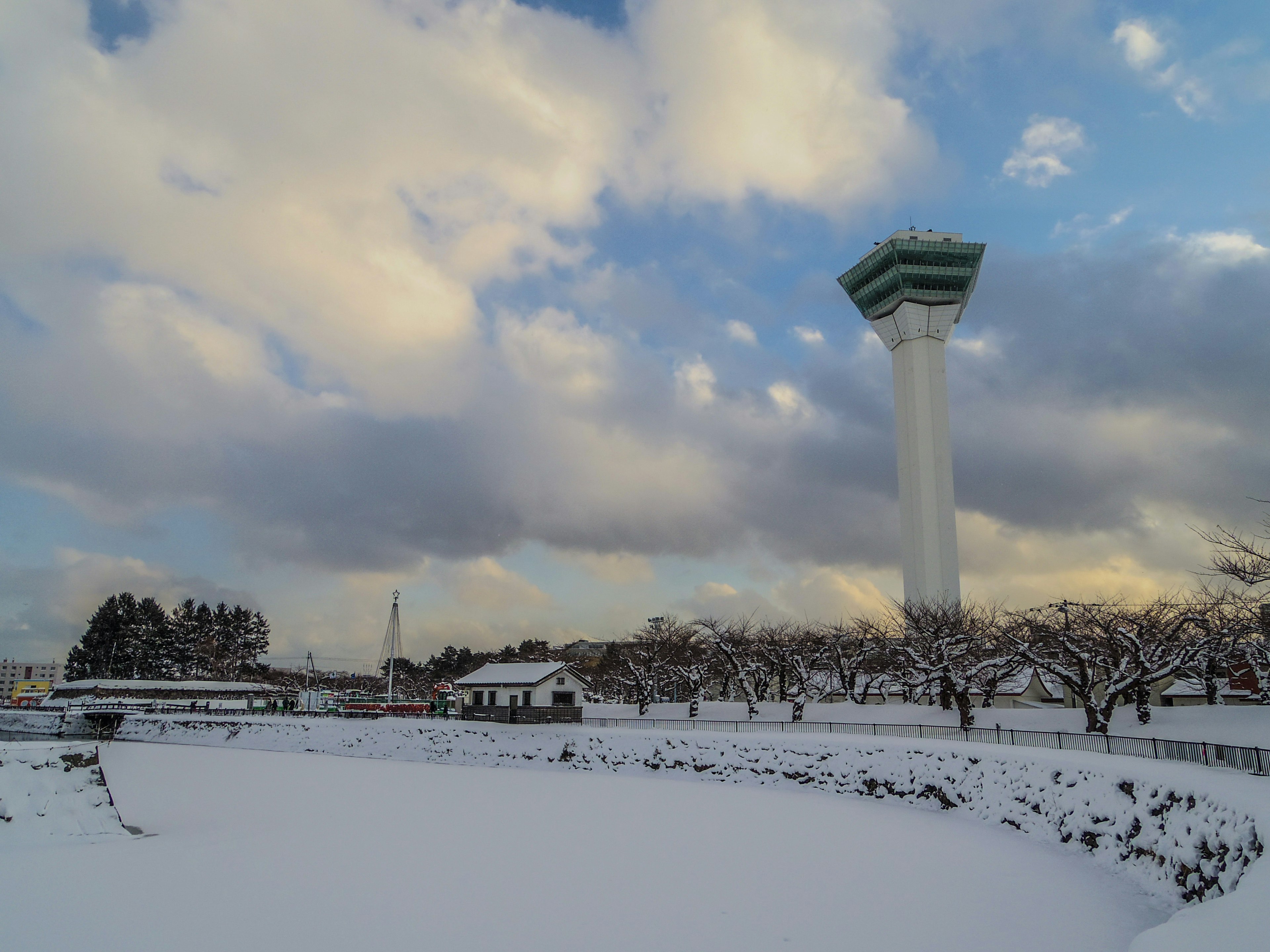 Tall tower in a snowy landscape with a cloudy sky