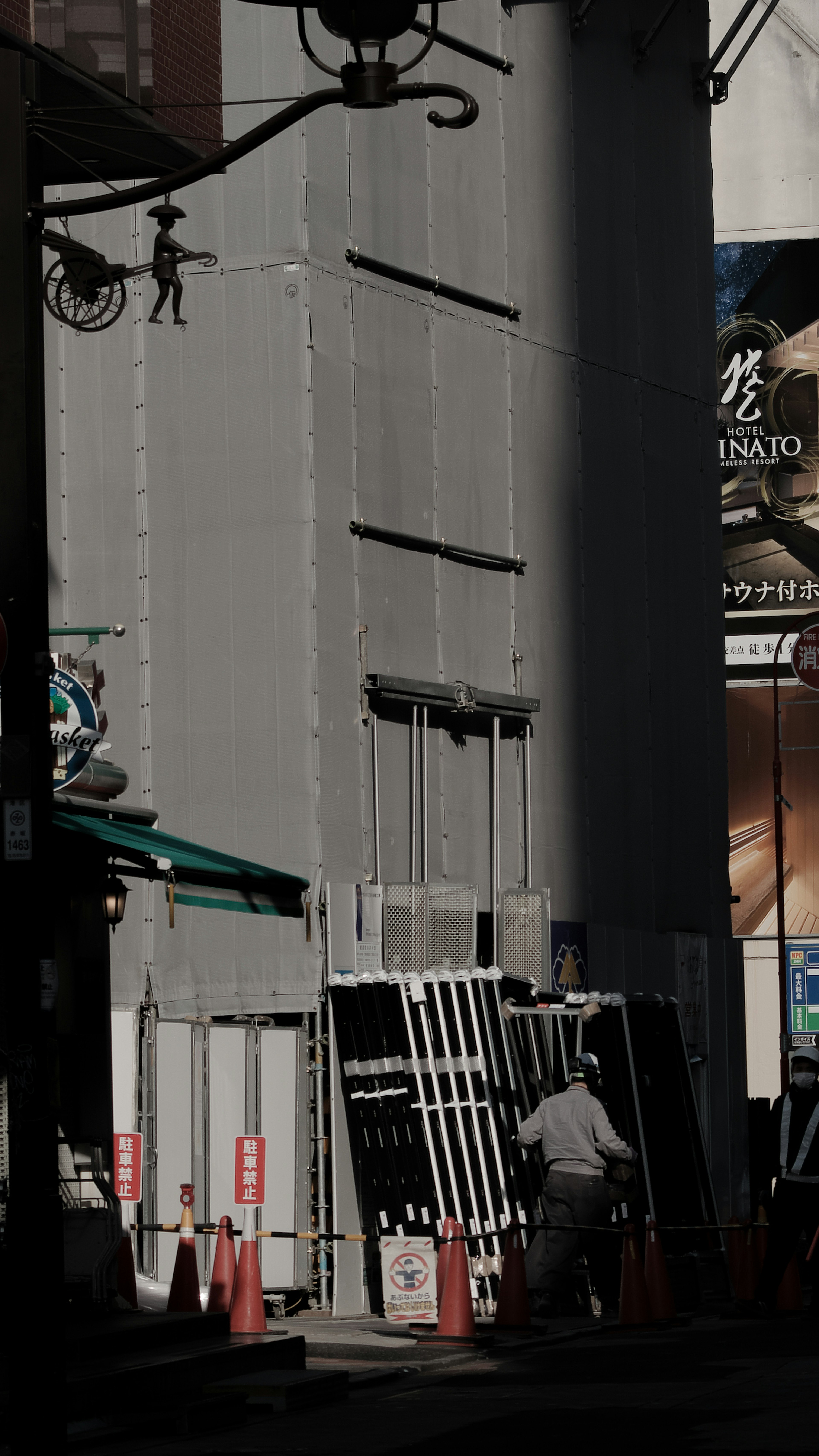 Exterior of a building in a dimly lit street with construction elements