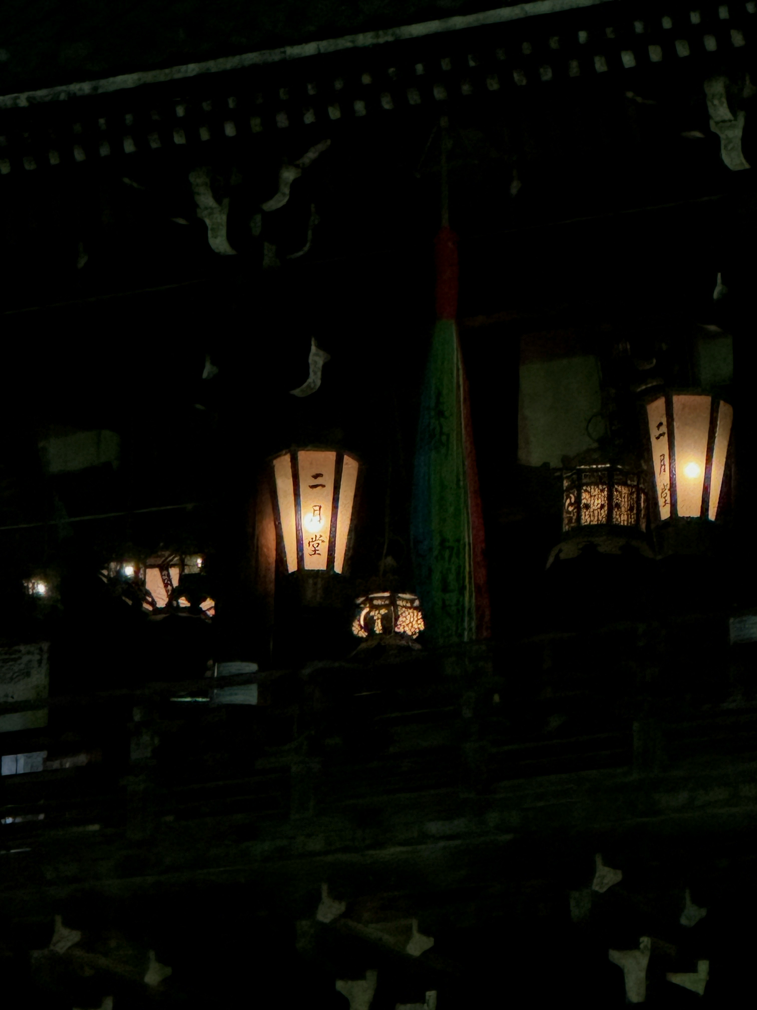 Traditional building with lanterns and colorful decorations in a dark environment