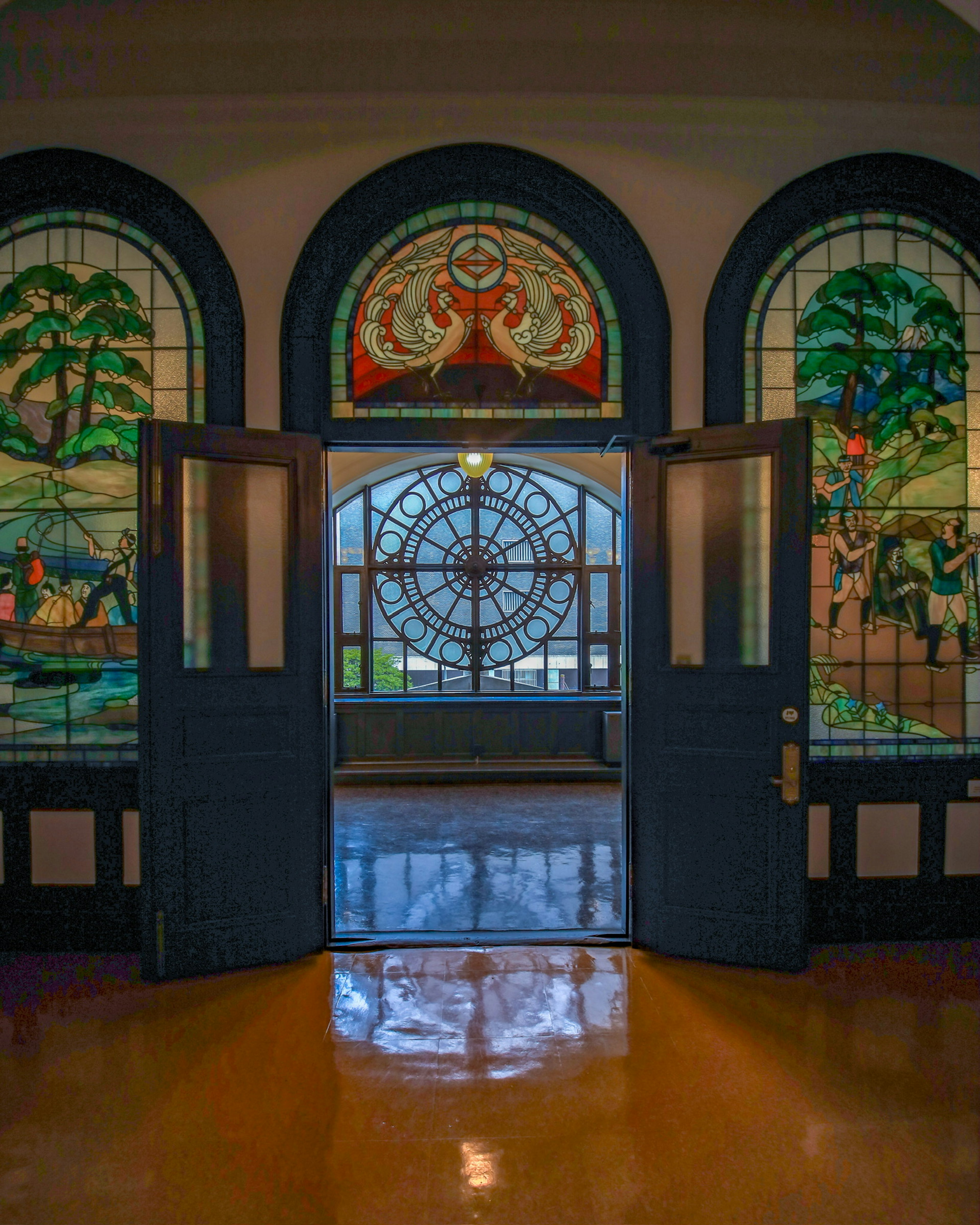 View of an open door framed by beautiful stained glass windows