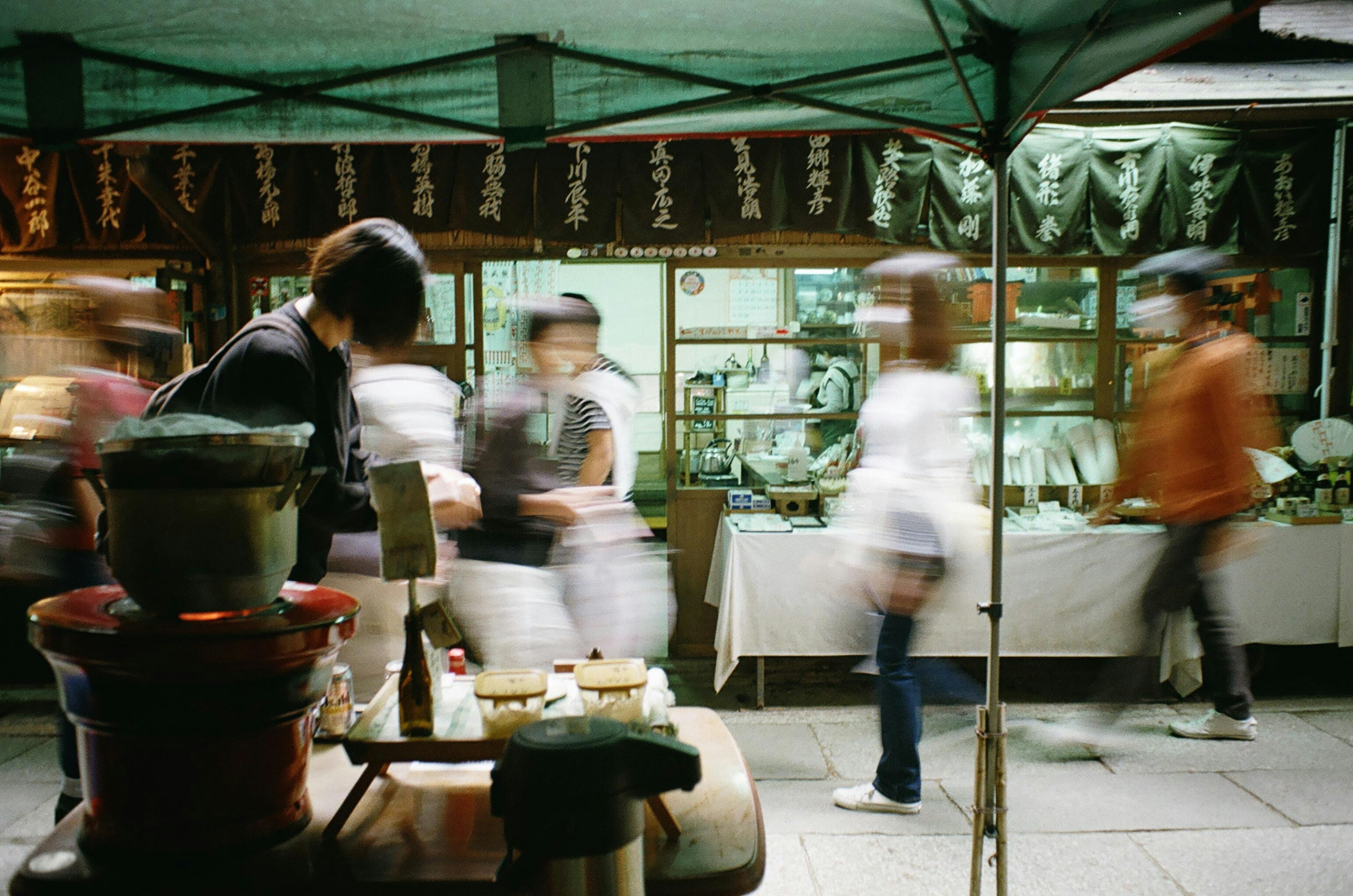 Busy street market scene with people walking