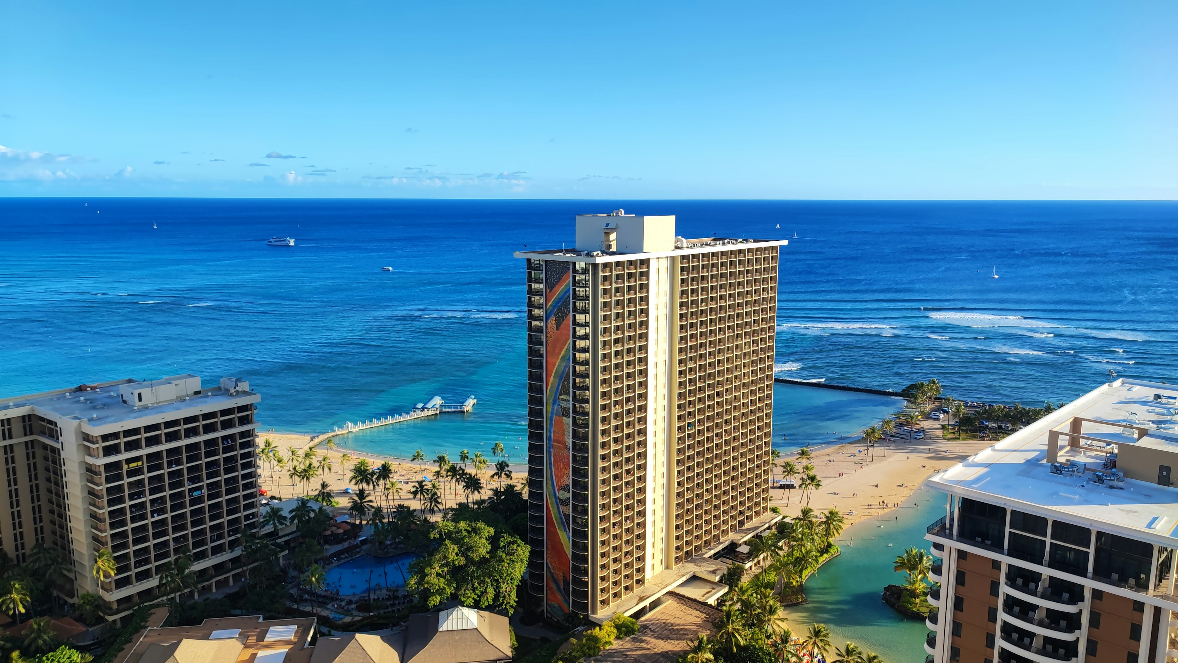 Aerial view of high-rise buildings overlooking a blue ocean in Honolulu