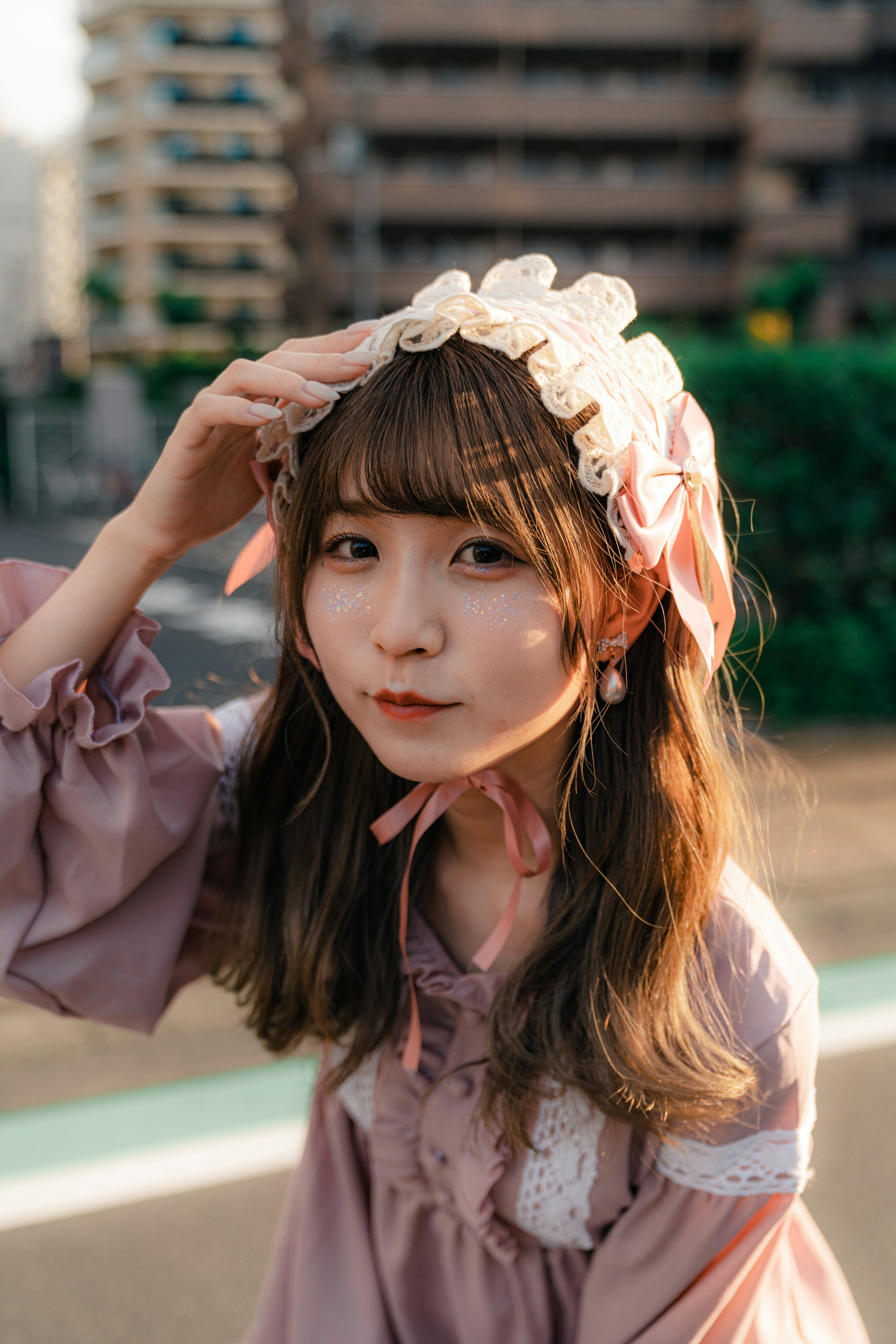 Young woman wearing a soft-colored dress with a ribbon in her hair