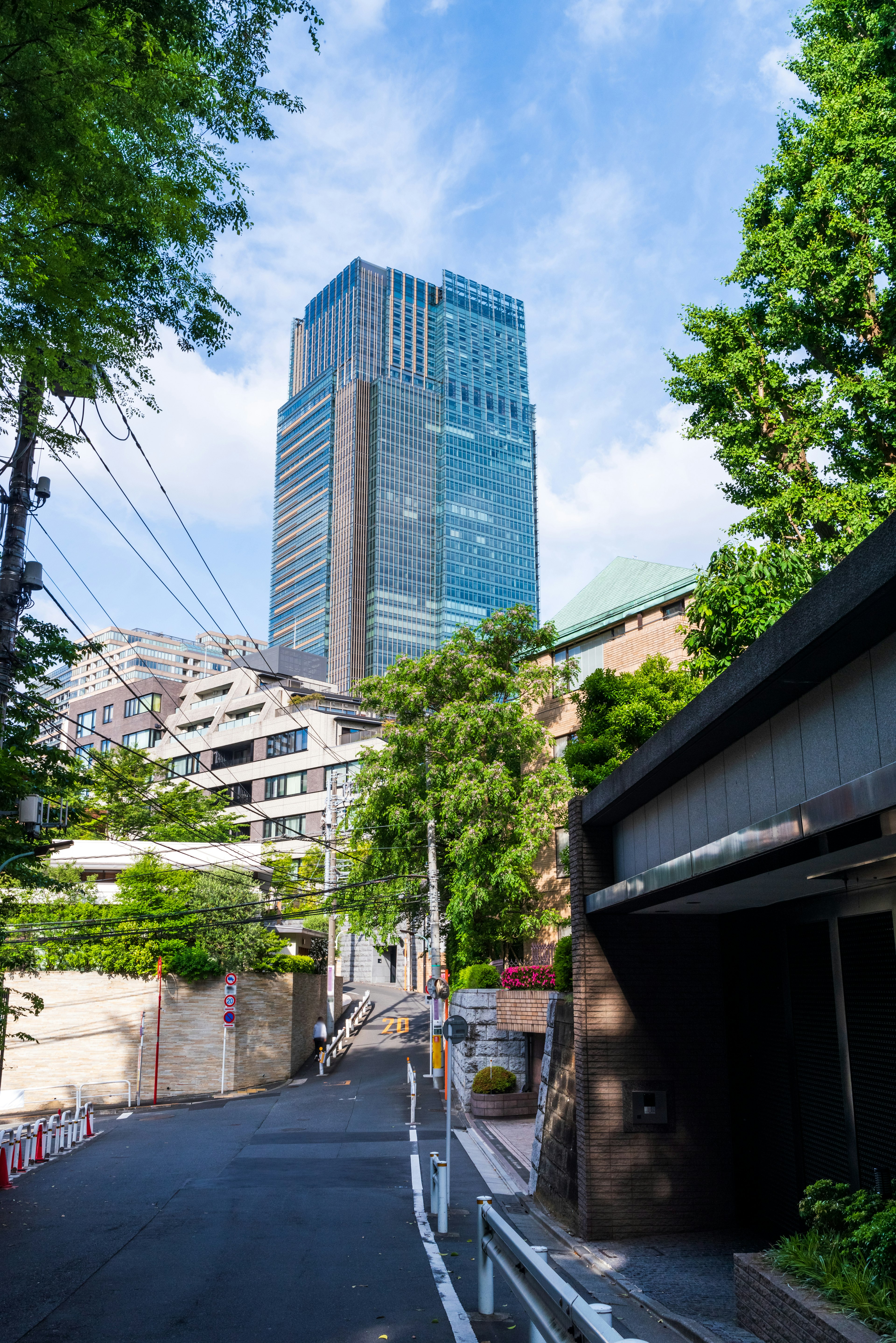 Urban landscape featuring a tall building and lush greenery