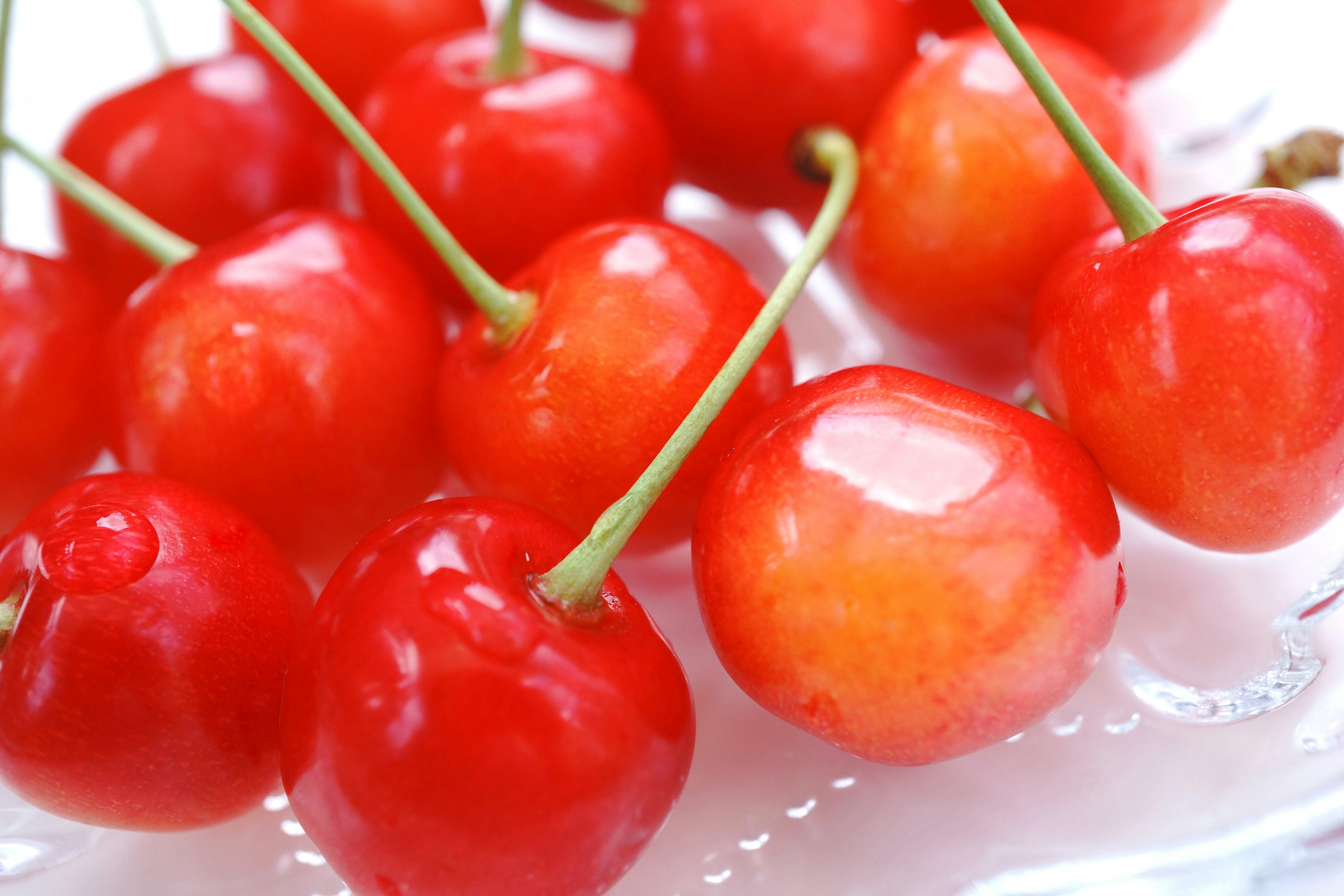 Vibrant red cherries arranged on a plate