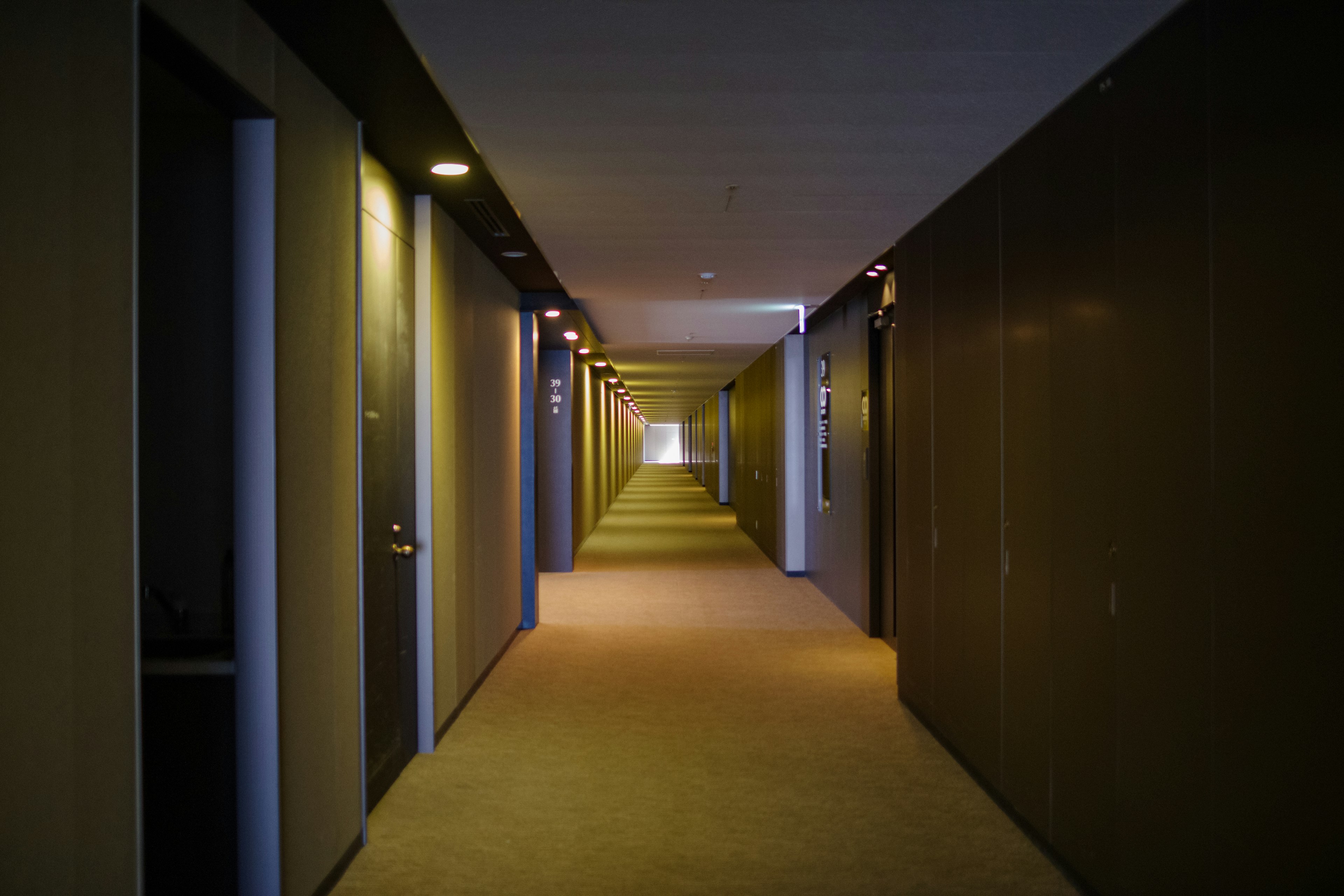 Long hotel corridor with doors on both sides