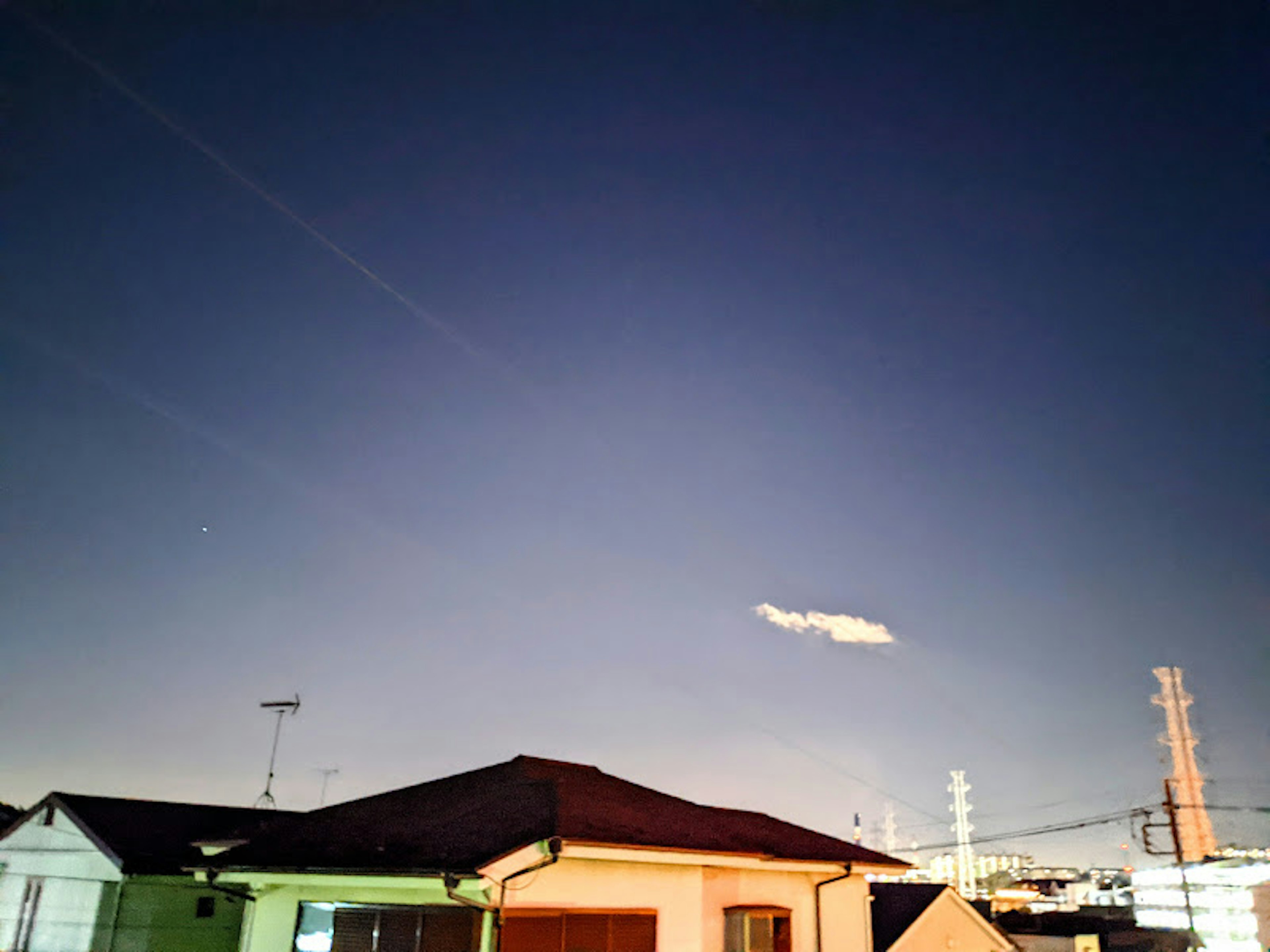 Night sky with a cloud and houses in view