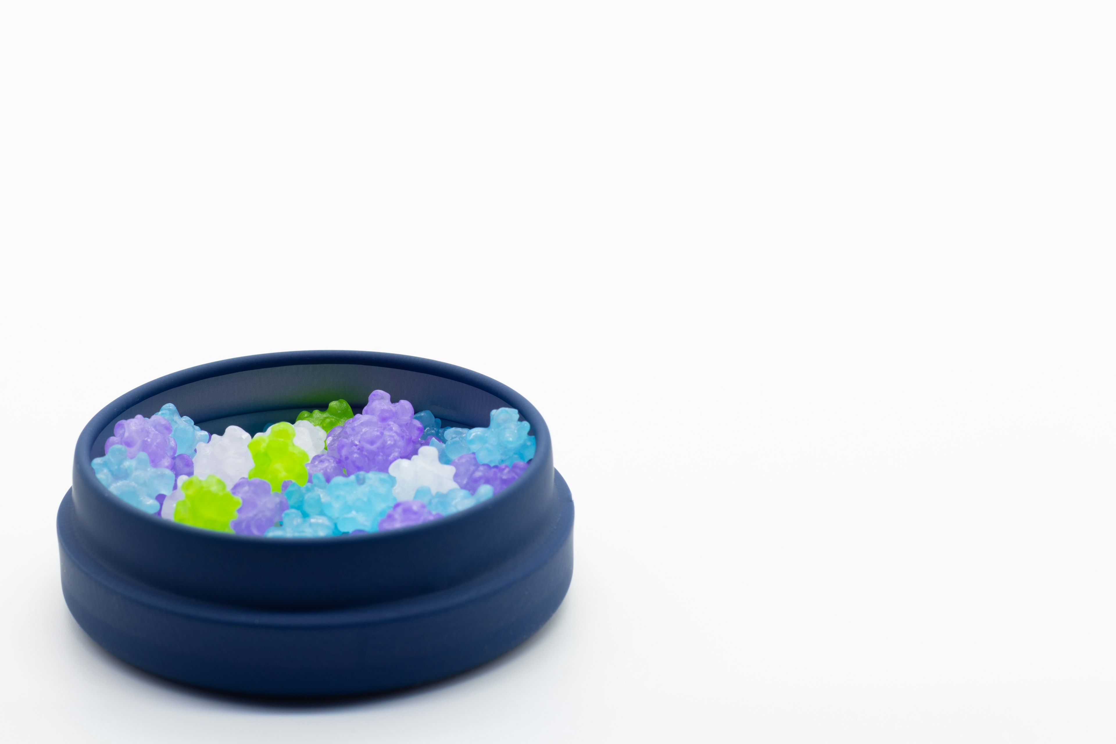 Colorful jelly-like beads in a blue container