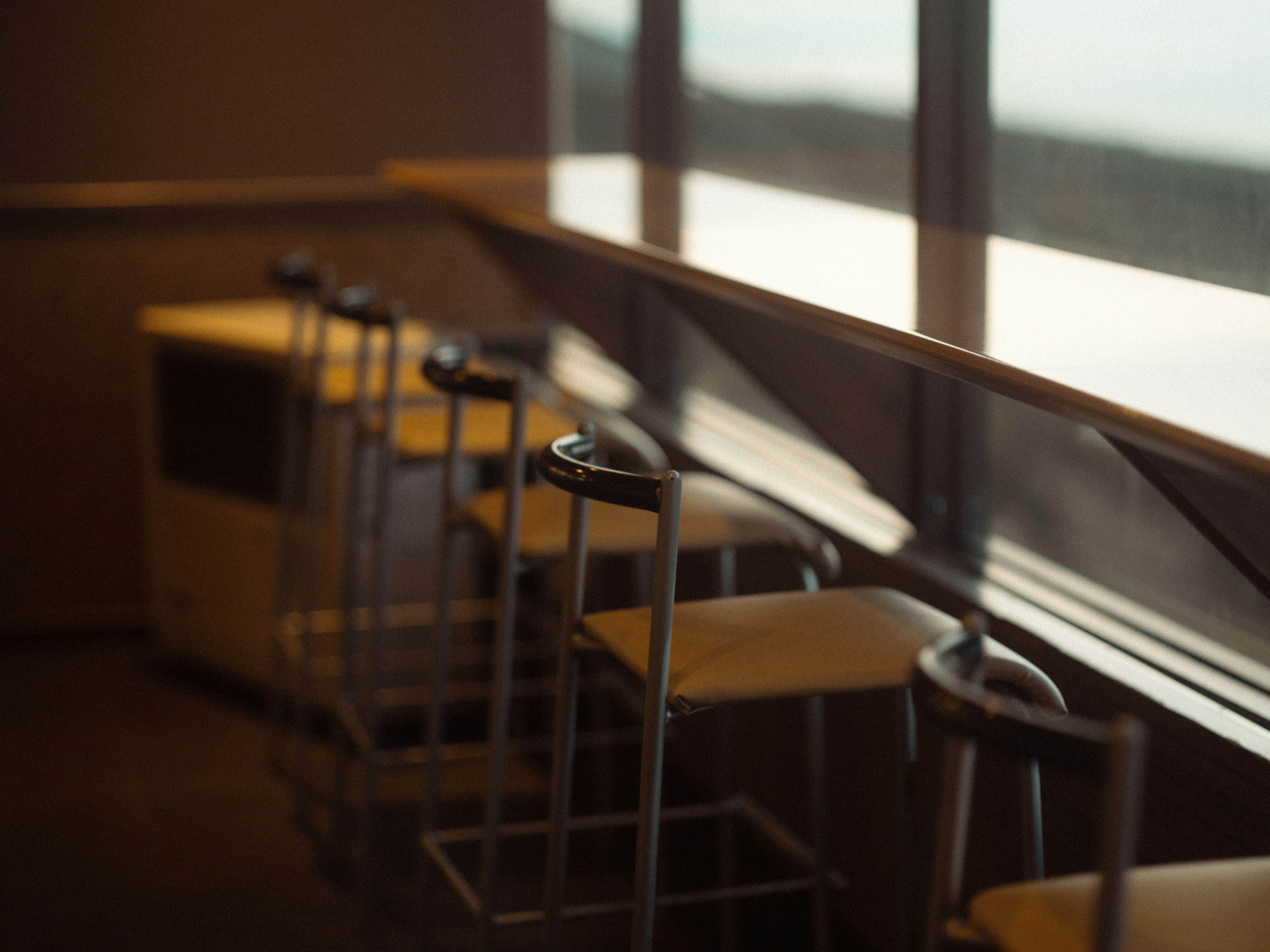 Counter chairs and part of a table near the window