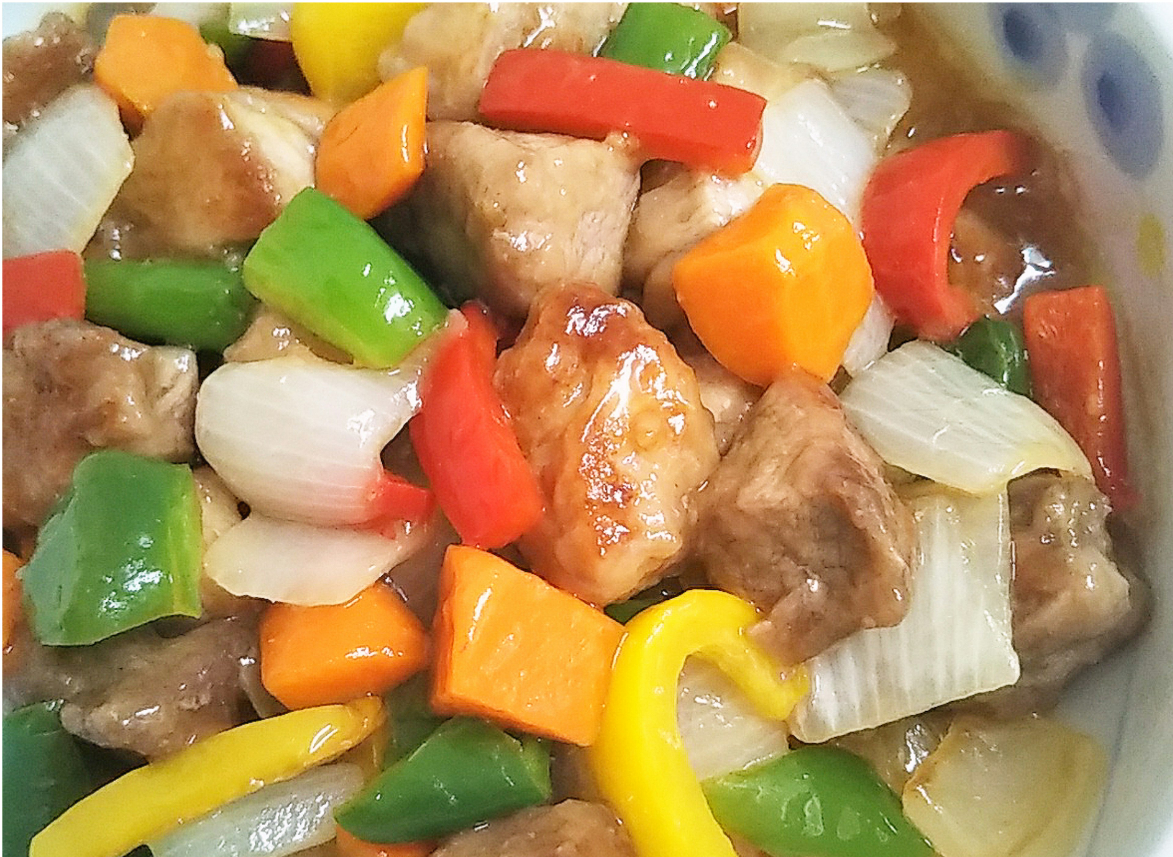 Colorful stir-fried vegetables and chicken in a bowl