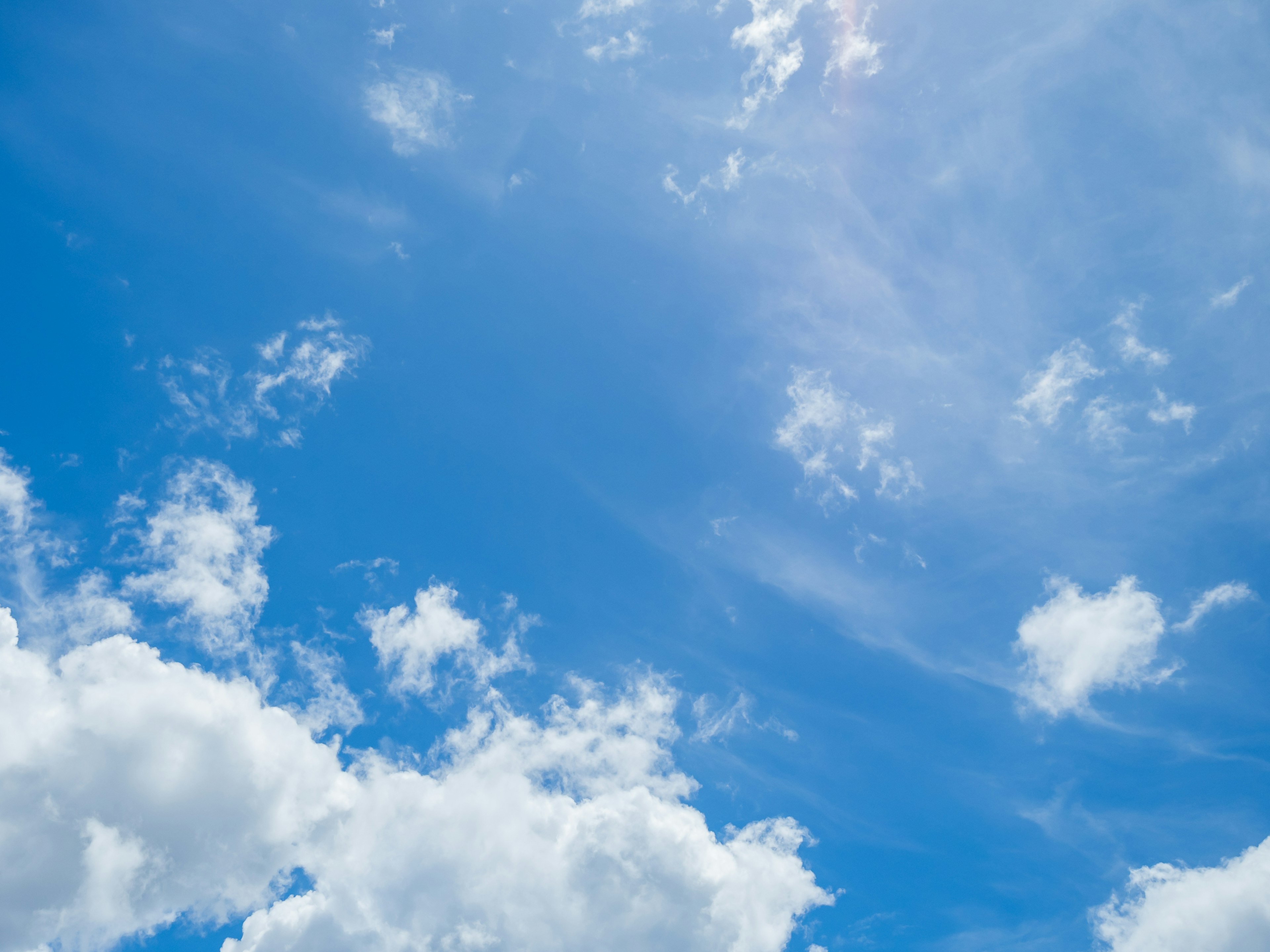 Bright blue sky with fluffy white clouds