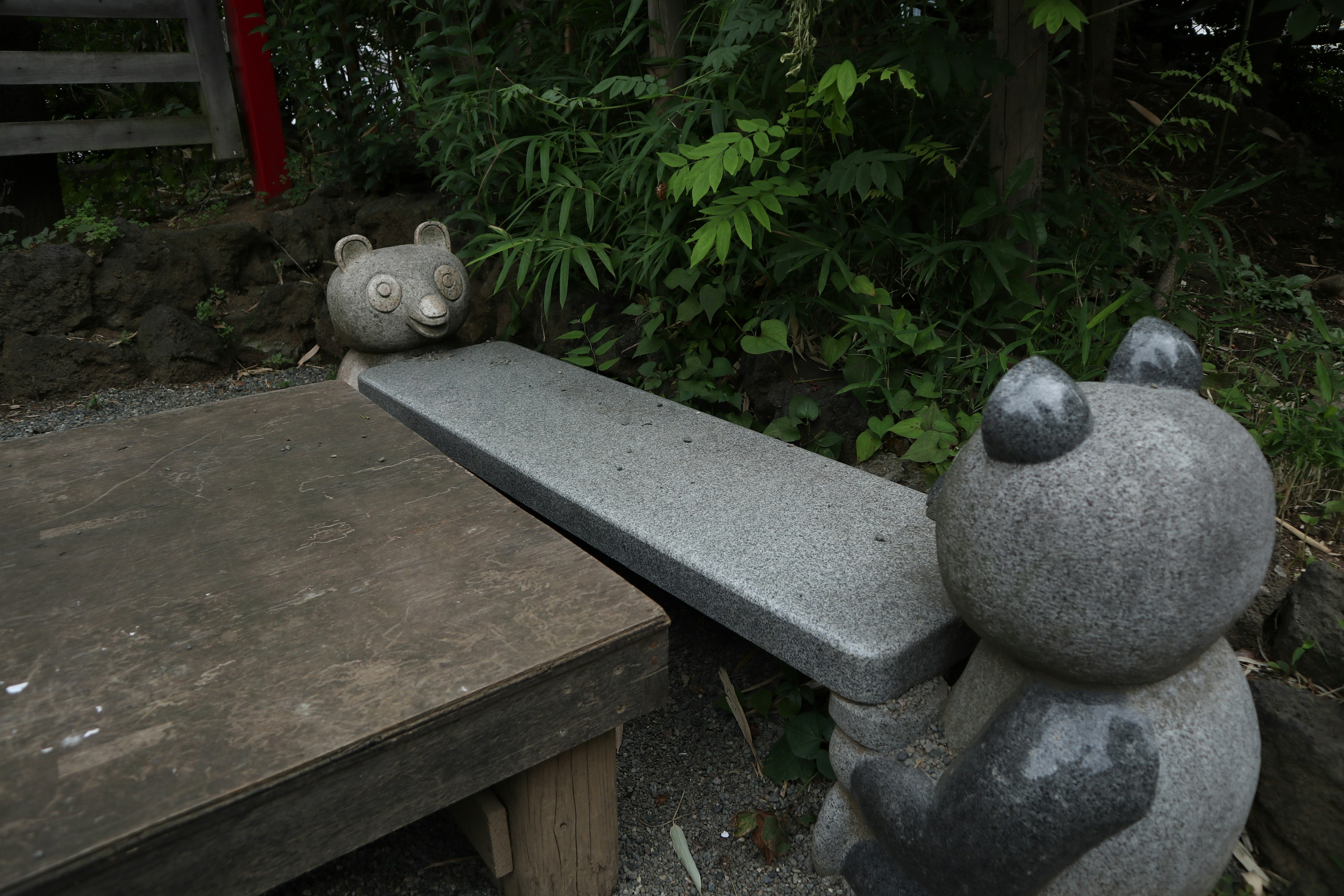 Stone animal bench and table set against a green background