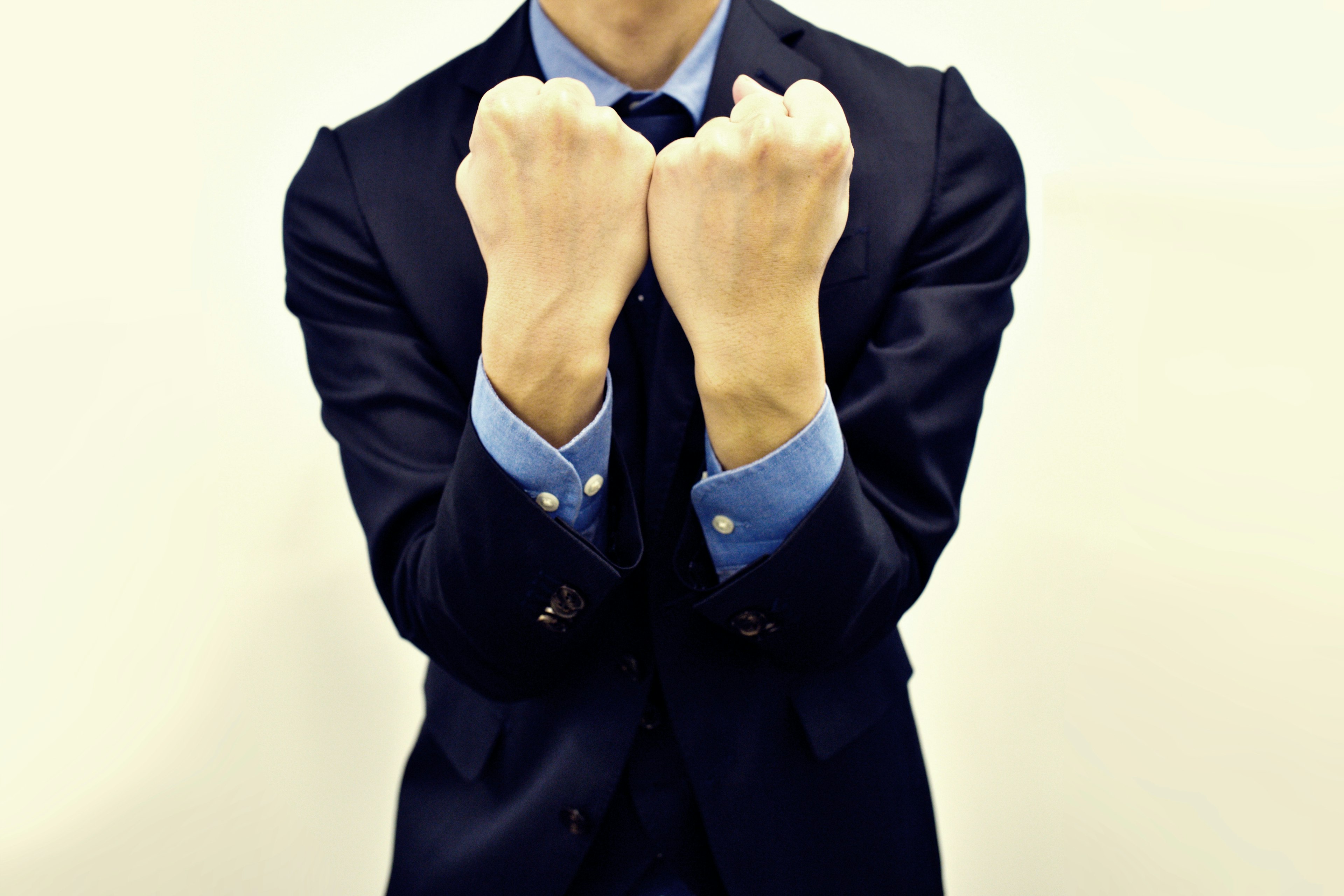 A man in a suit with clenched fists