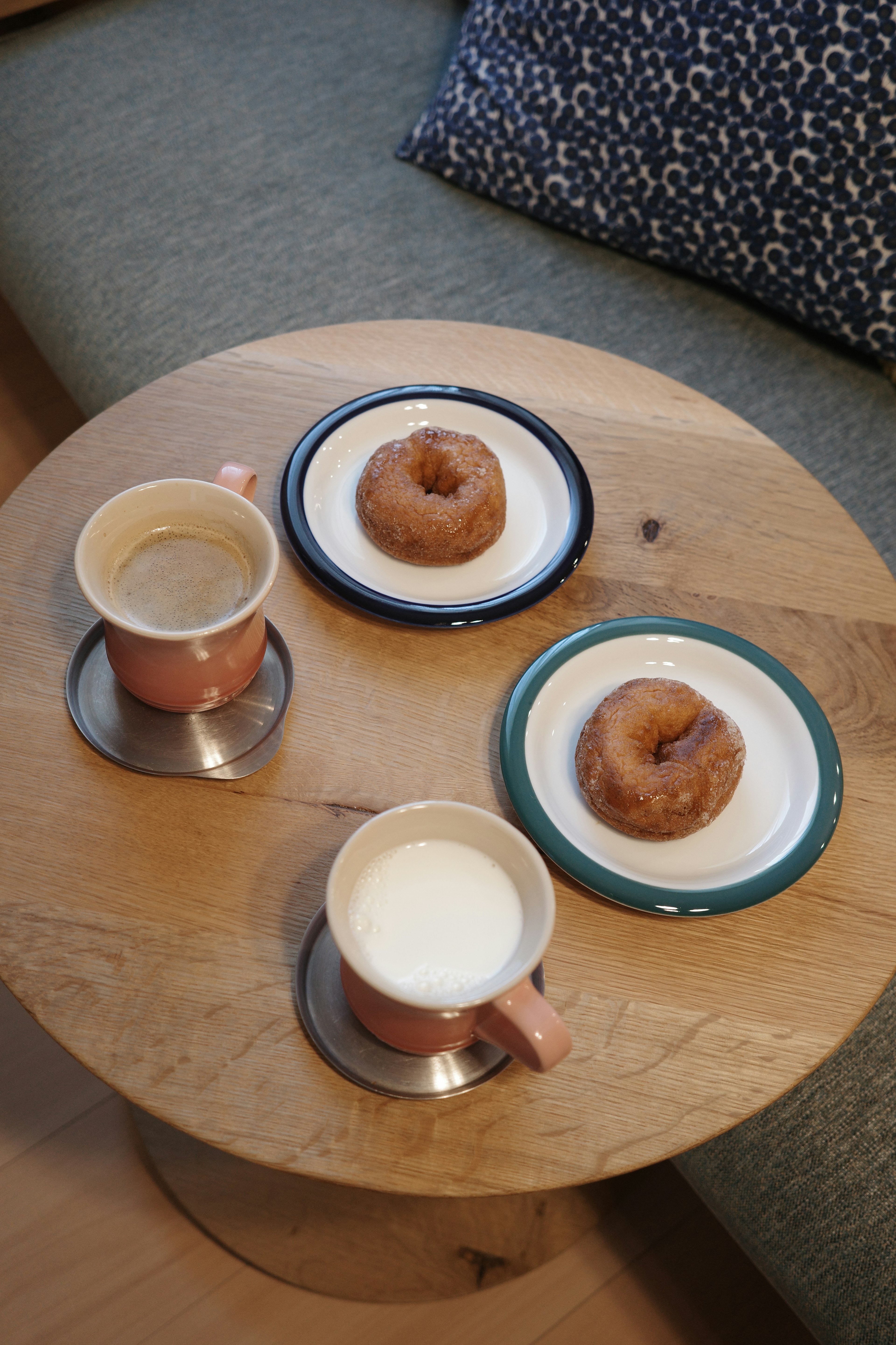 Coffee and donuts arranged on a wooden table