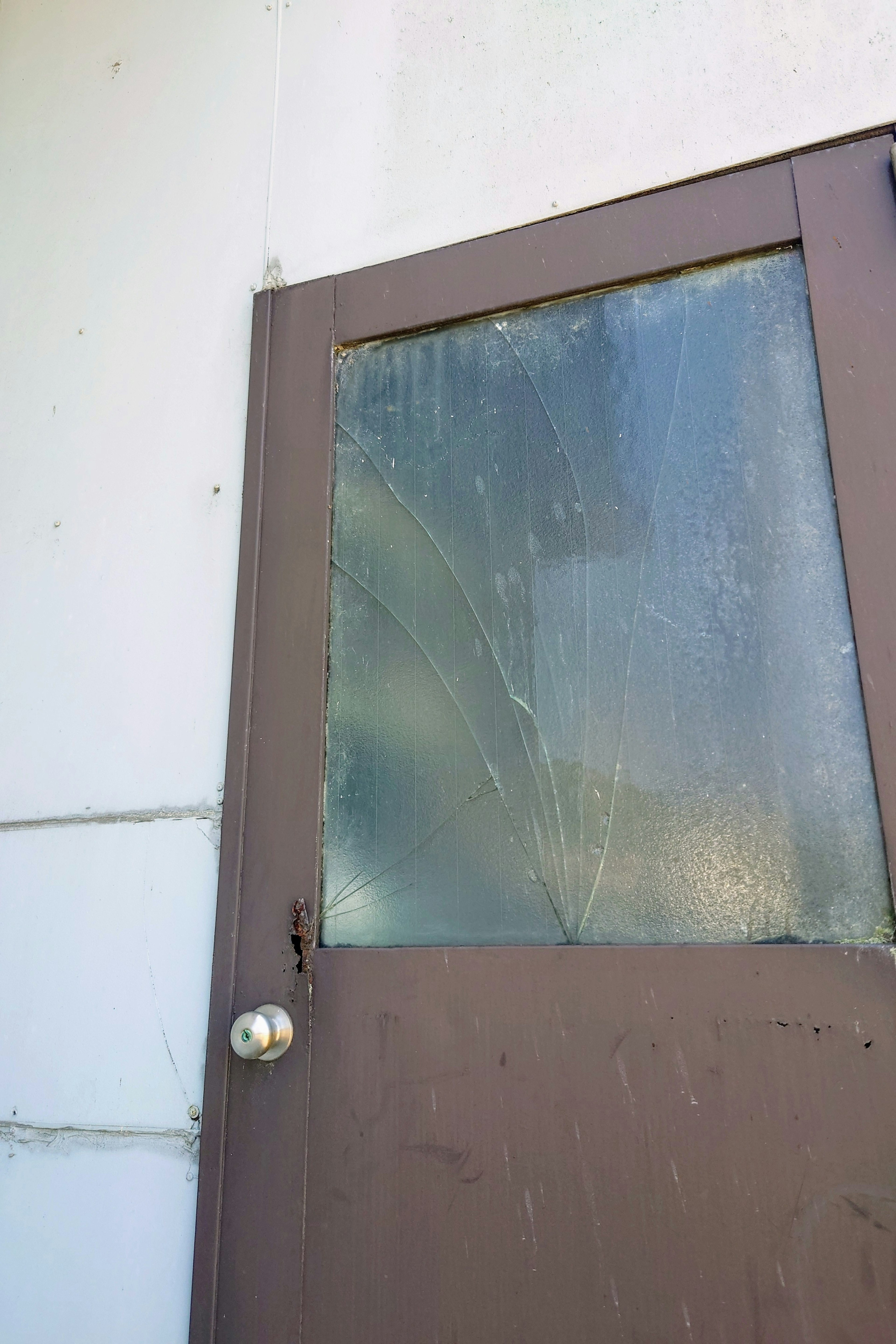 Old wooden door with cracked glass window