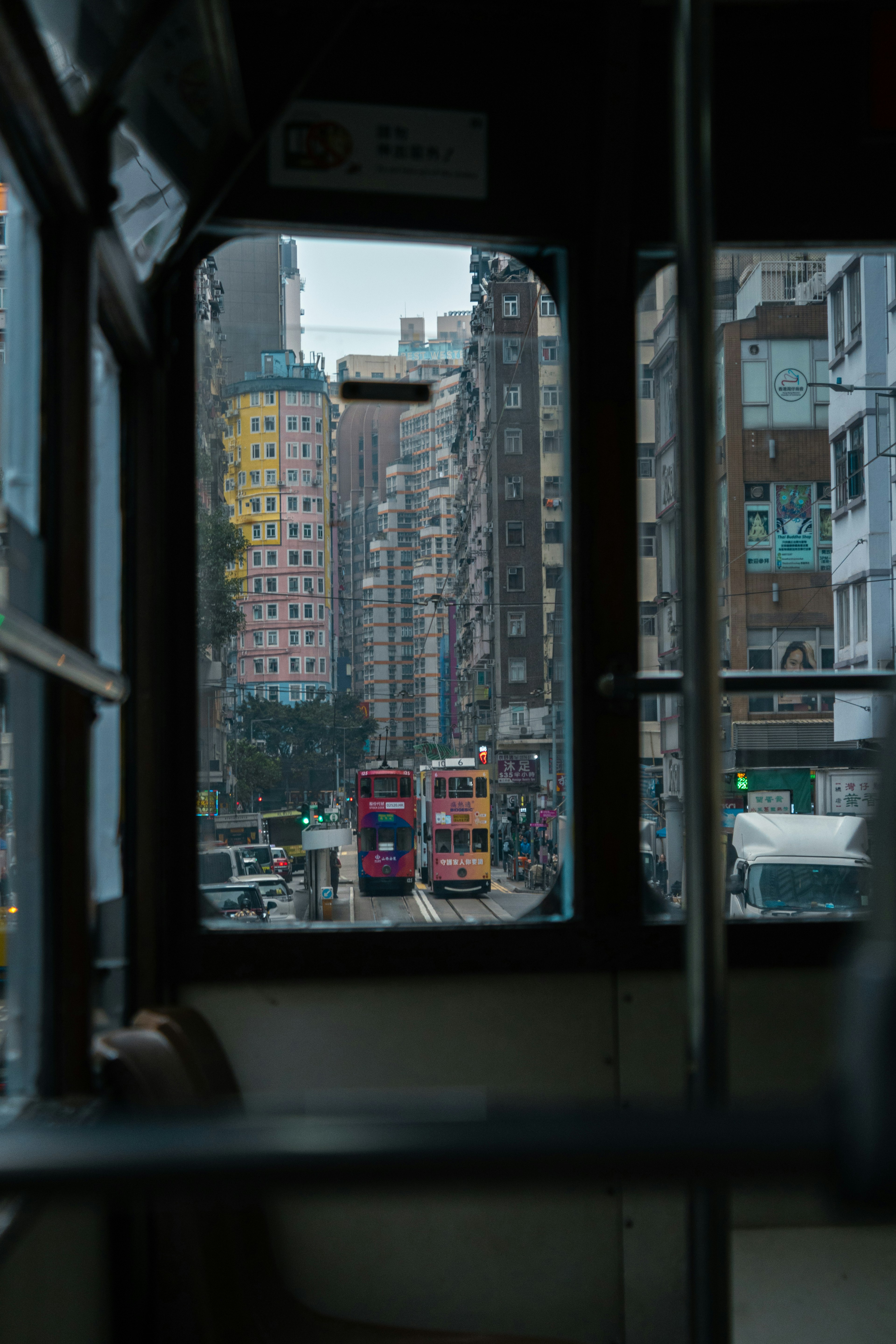 View of Hong Kong street and colorful trams through tram window