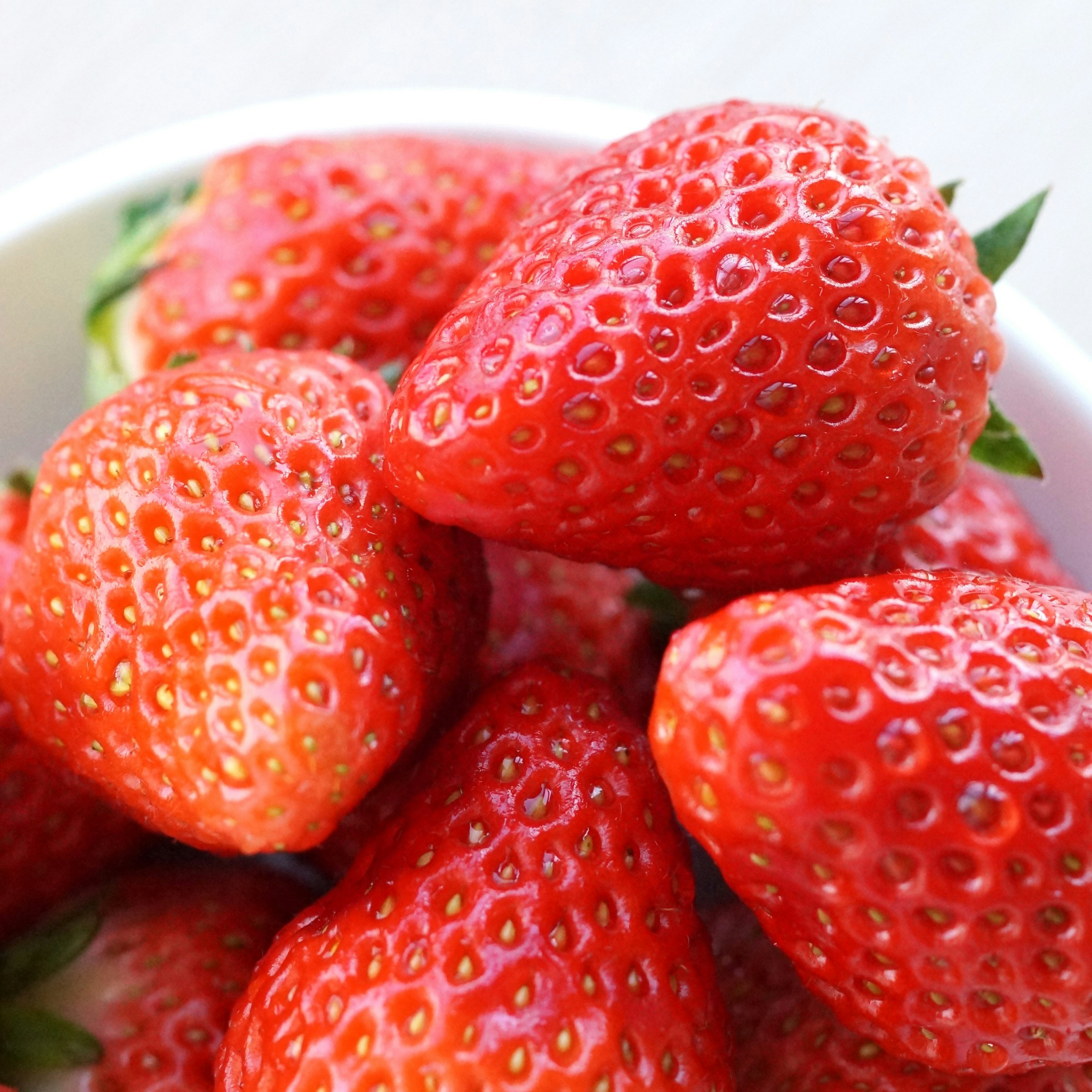 Vibrant red strawberries piled in a bowl