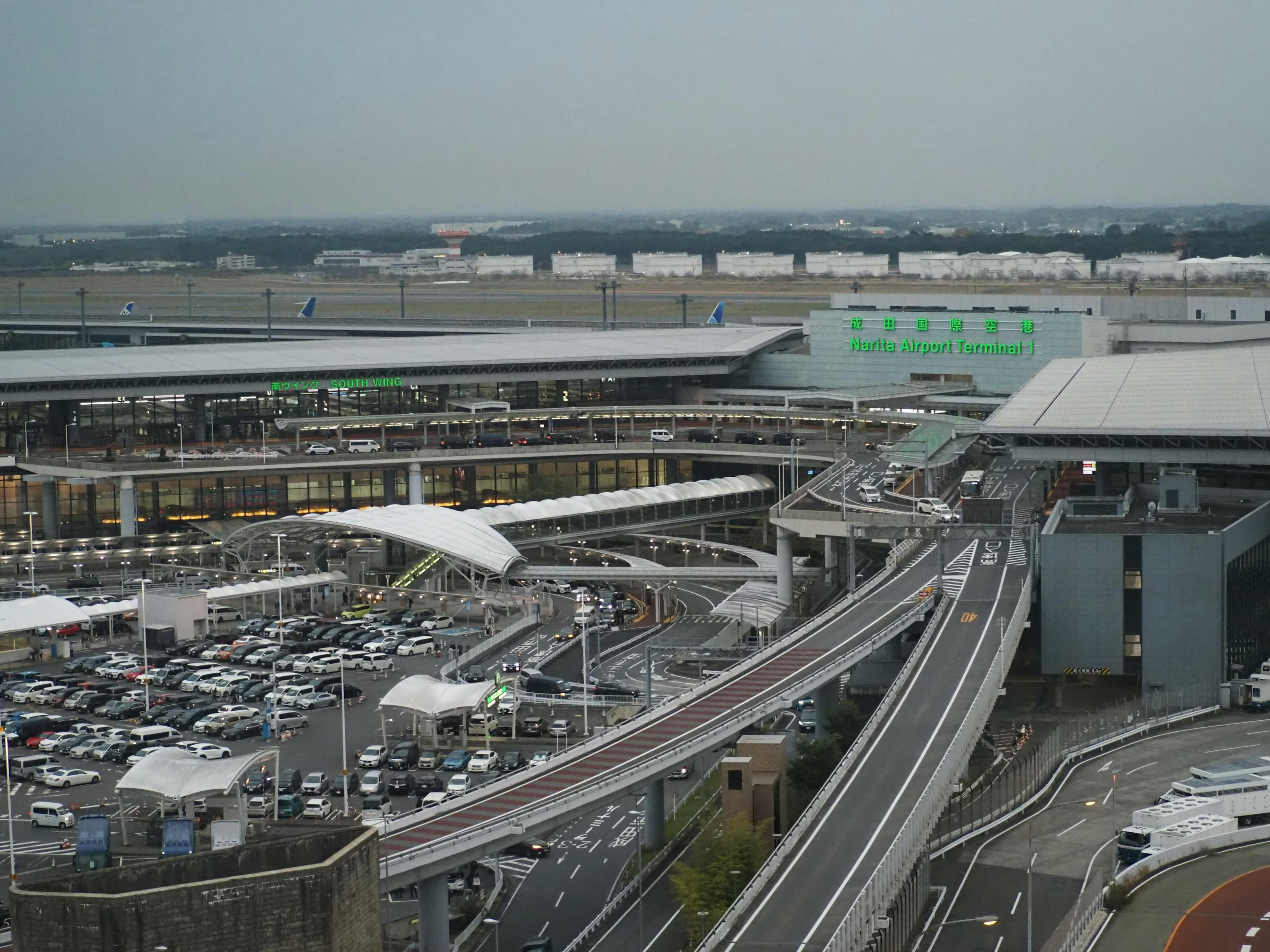 Aerial view of a large airport parking and transportation area