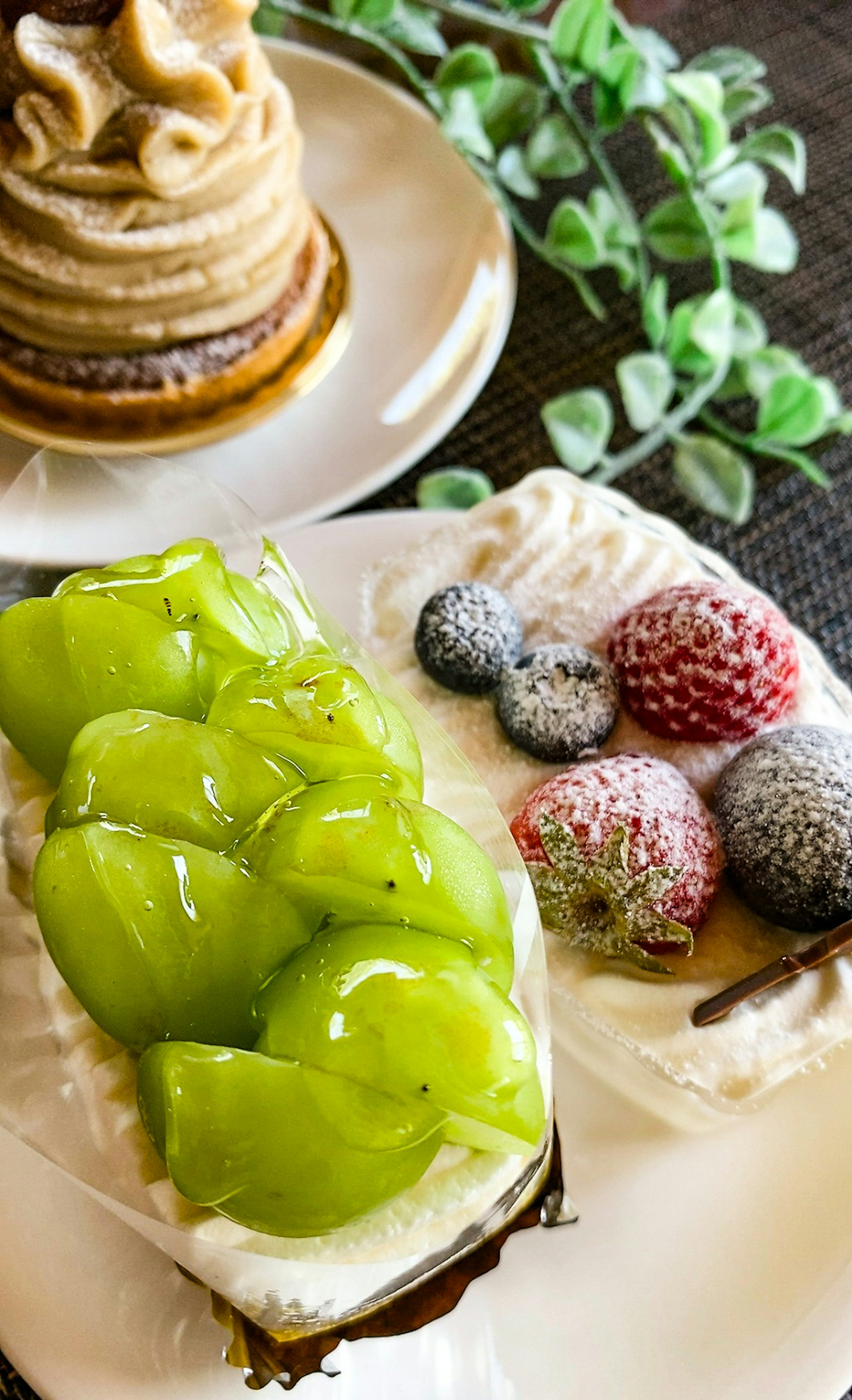 Dessert with green fruit topping and strawberries on a plate