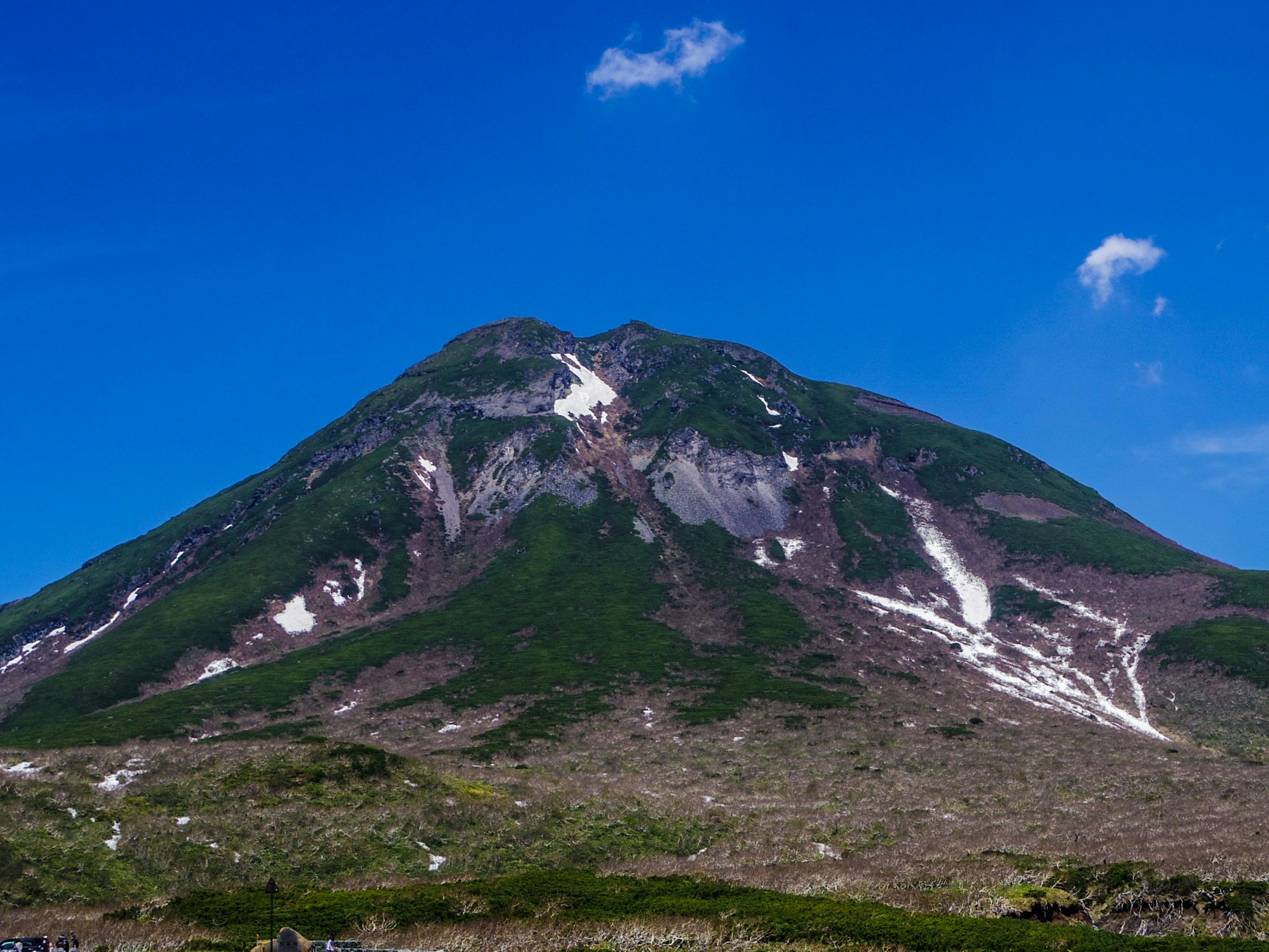 A beautiful volcano mountain towering under a clear blue sky