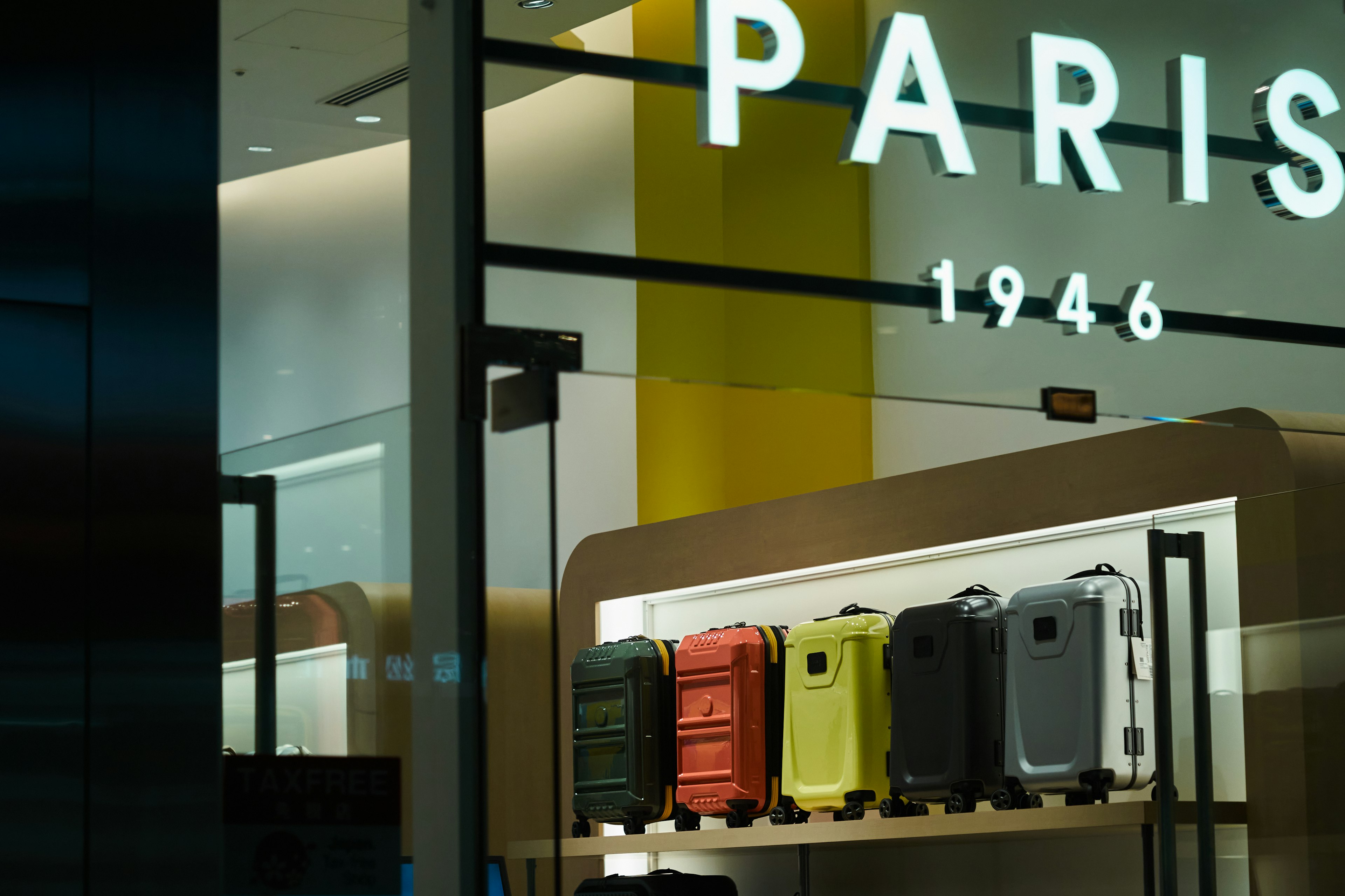 Colorful suitcases displayed in a Paris store window