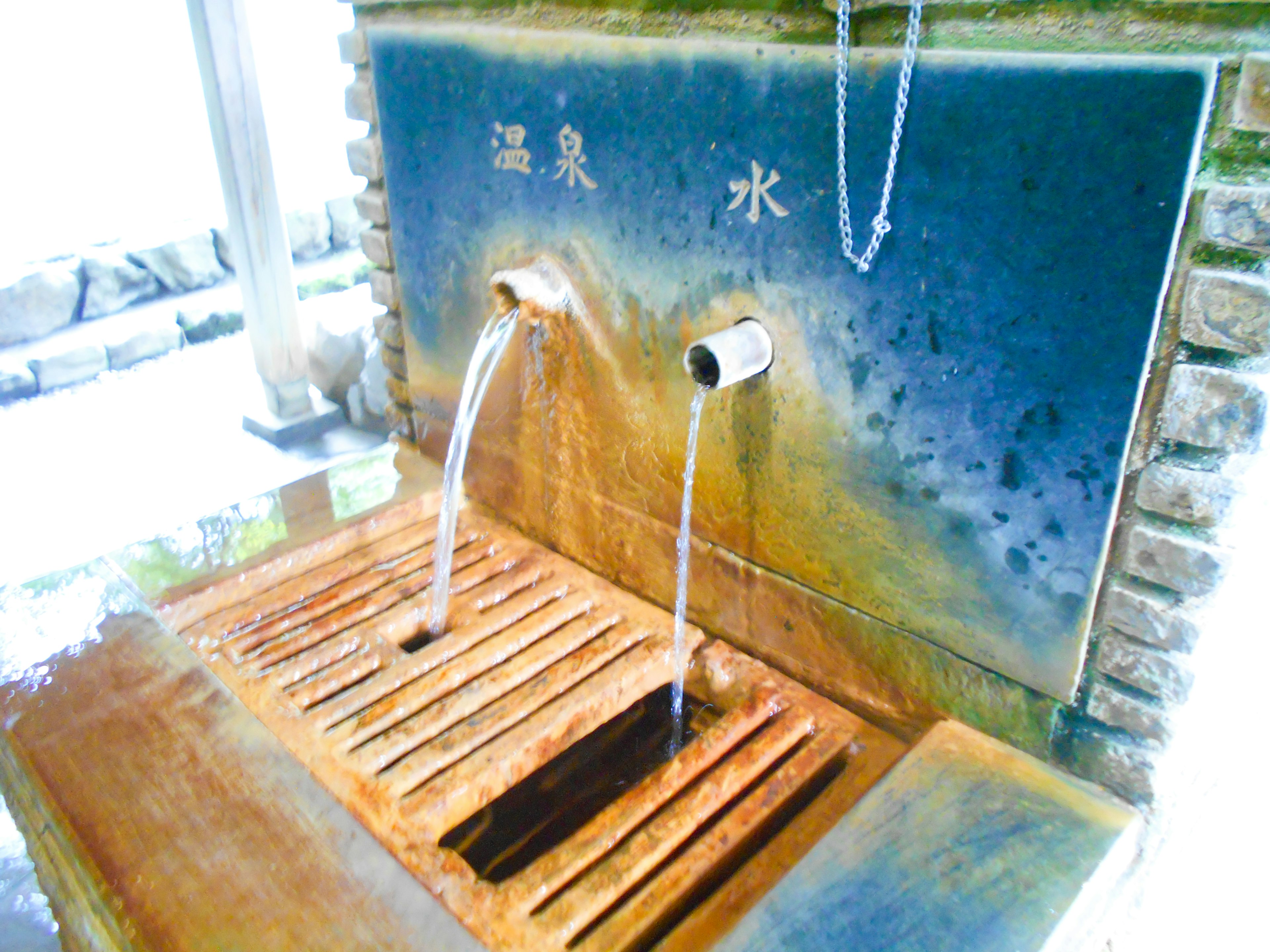 Spring water fountain with flowing mineral water