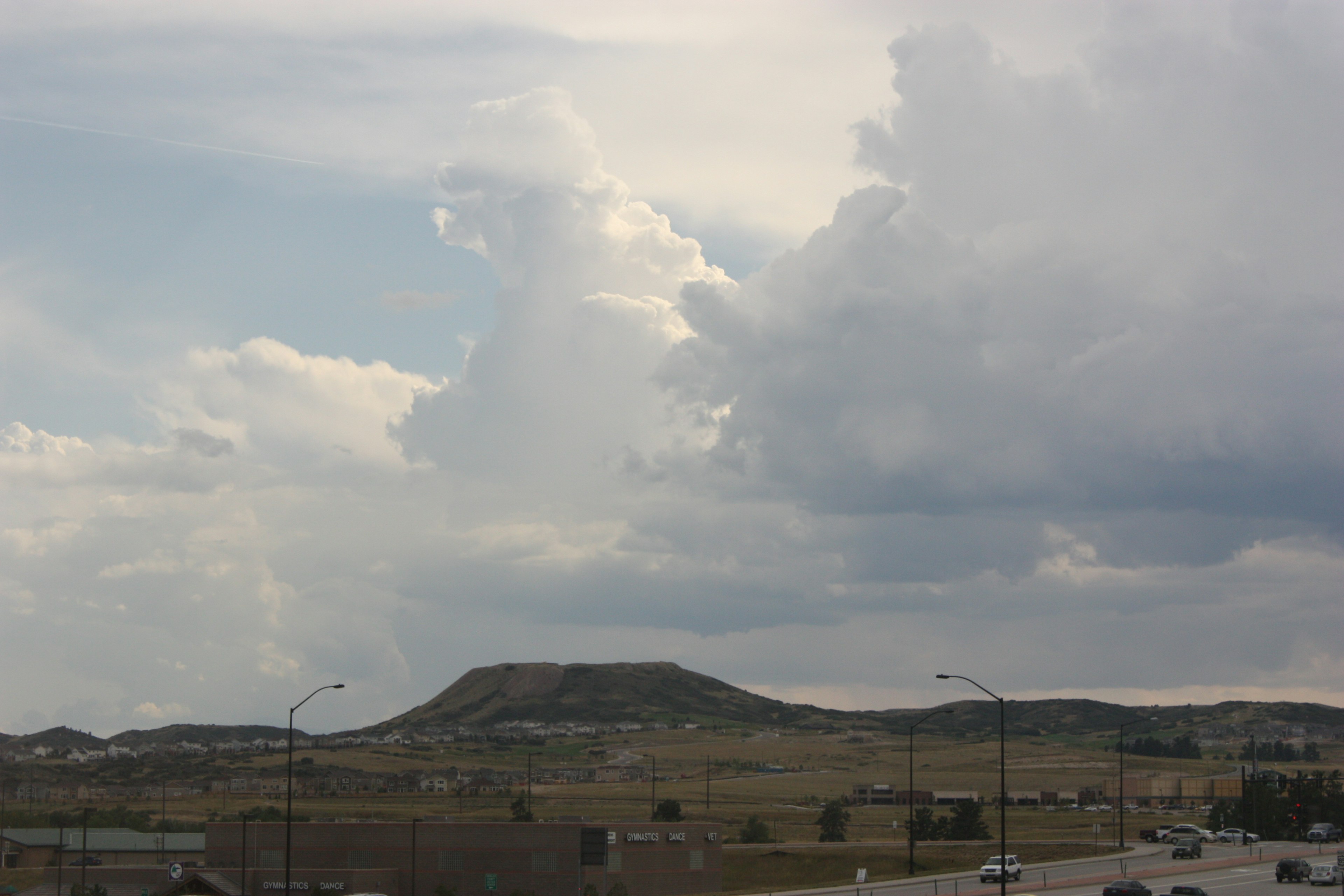 Landscape featuring hills and clouds in the sky