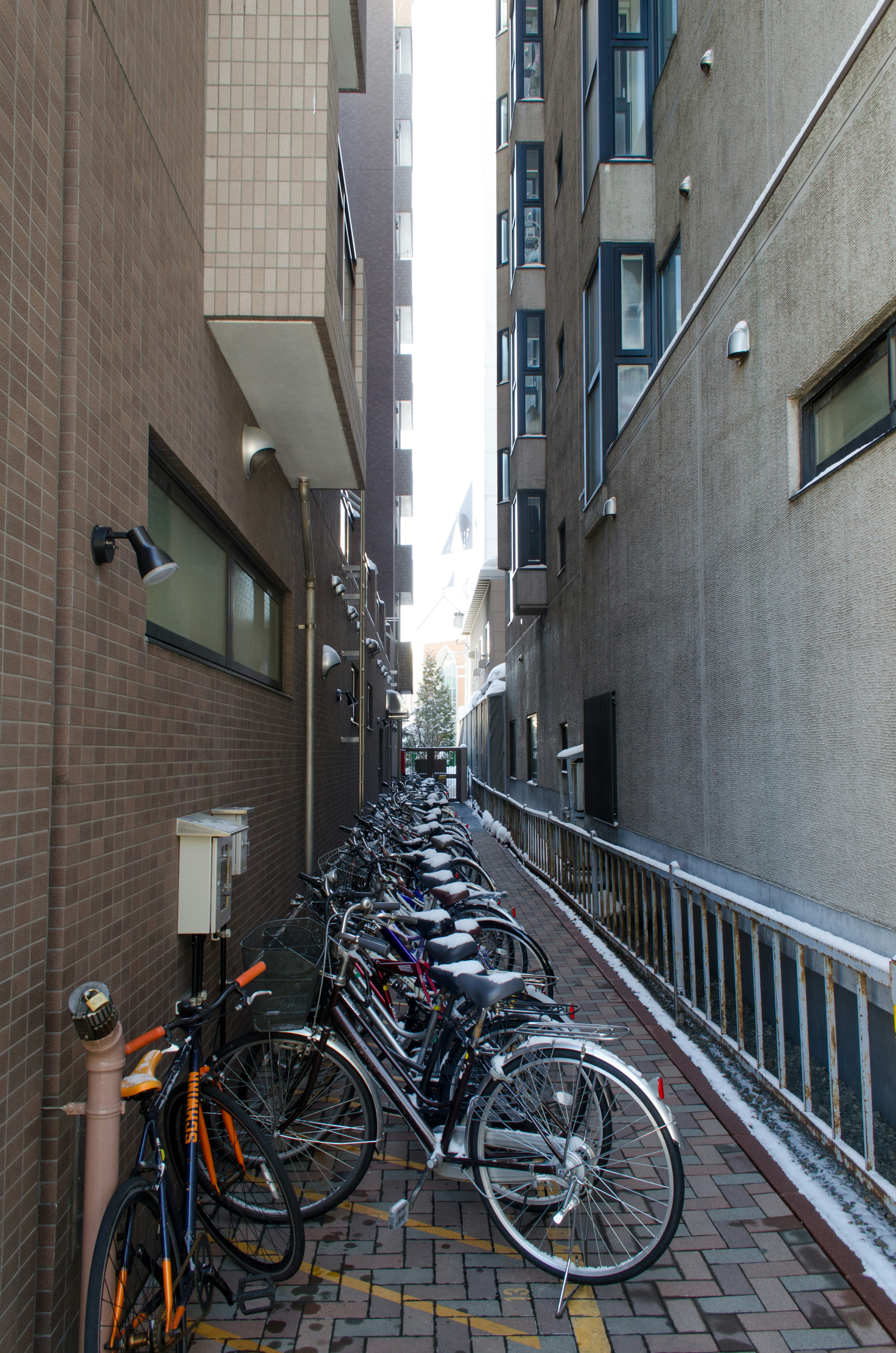 Narrow alley with parked bicycles and tall buildings